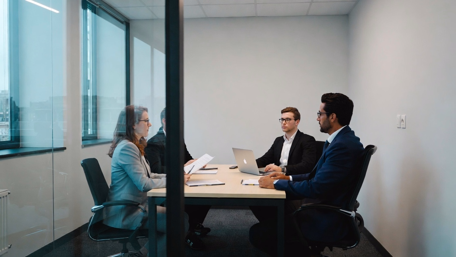 SMALL CONFERENCE ROOM An IT professional three people seated around a small