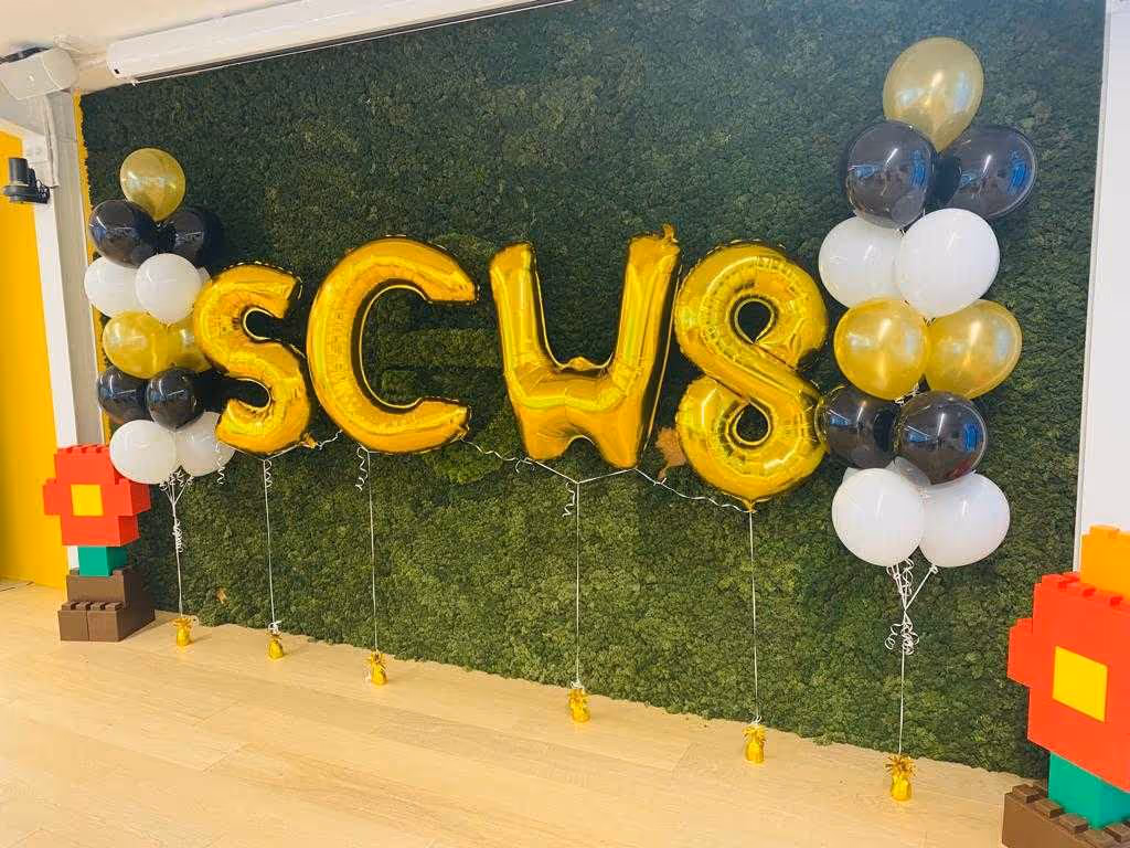 Balloons in the shape of "SCW 8" during the office birthday party.