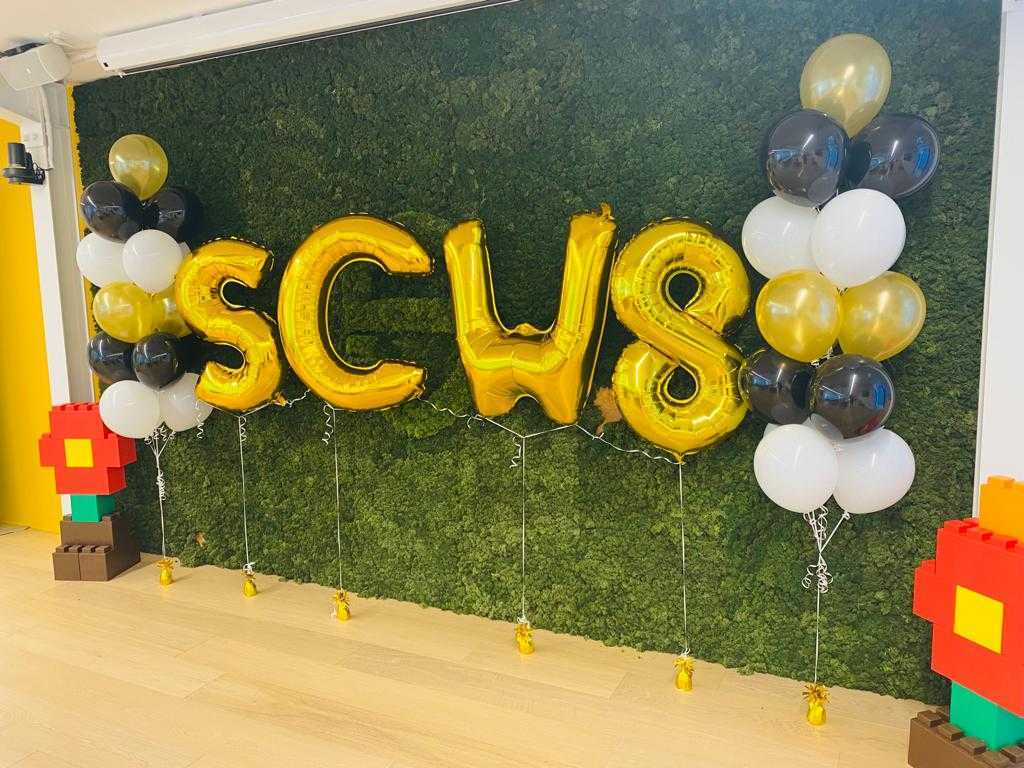 Balloons in the shape of "SCW 8" during the office birthday party.