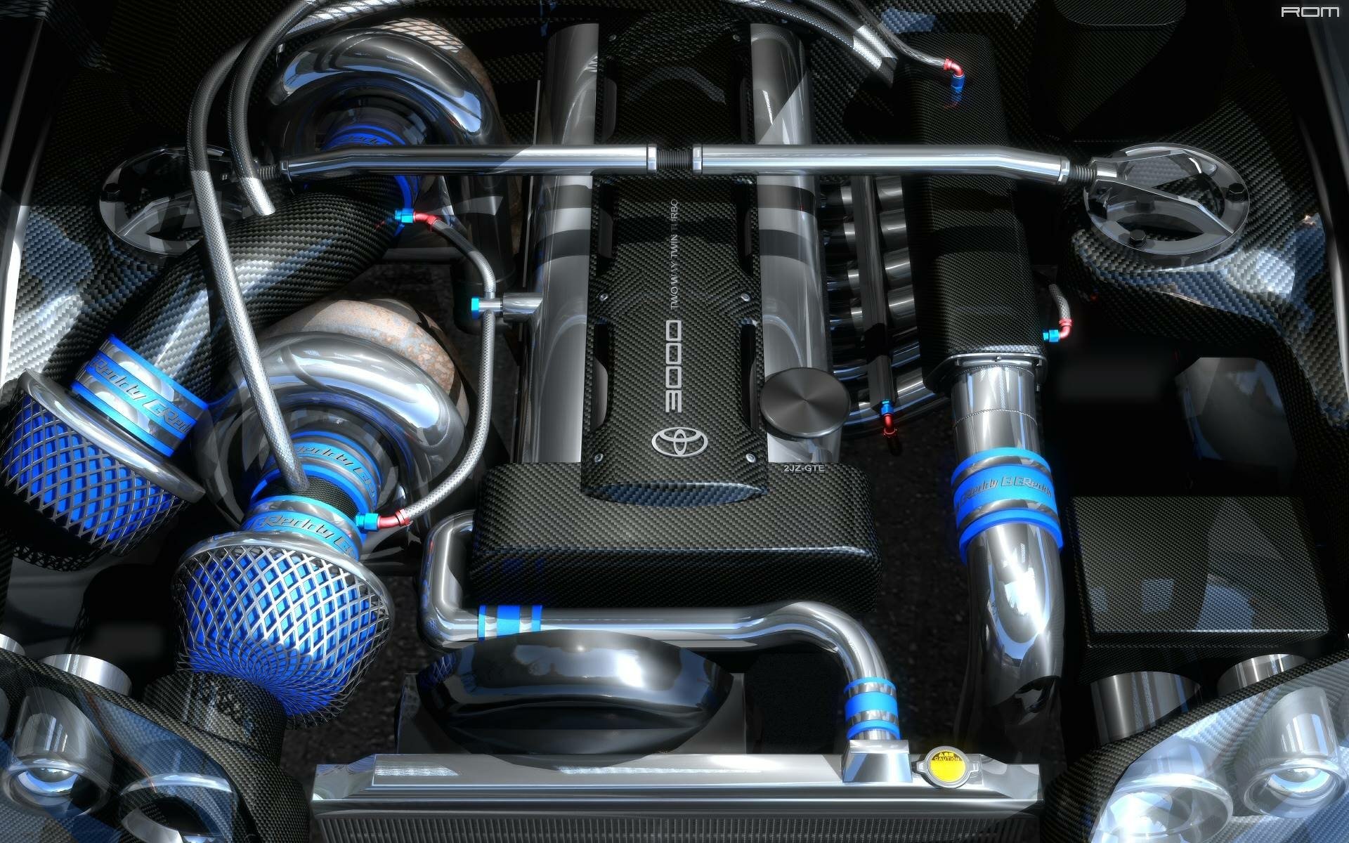 High-performance customized Toyota 2JZ-GTE twin-turbo engine bay featuring chrome piping, carbon fiber accents, and blue air filters.