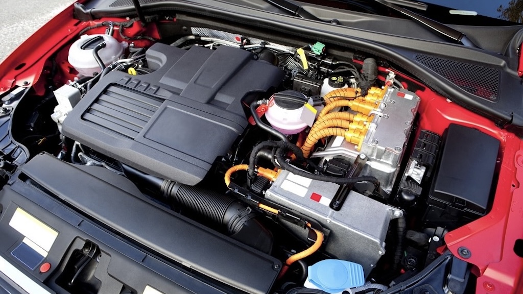 Hybrid engine bay with orange high-voltage cables and battery components