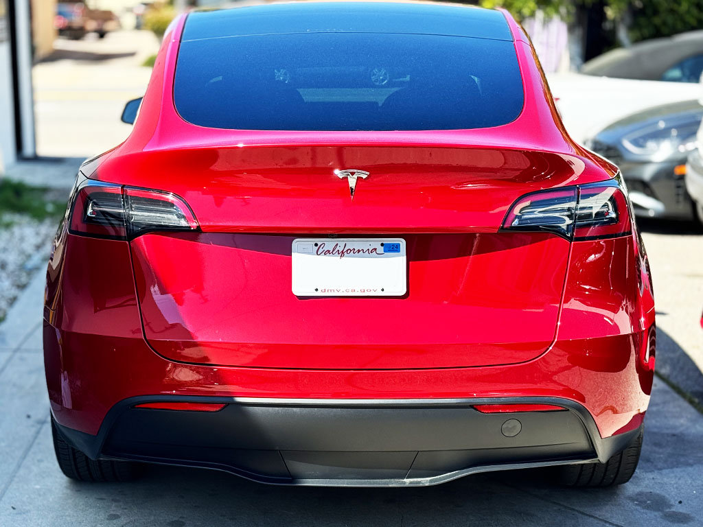 Red Tesla Model Y rear liftgate and bumper after repair