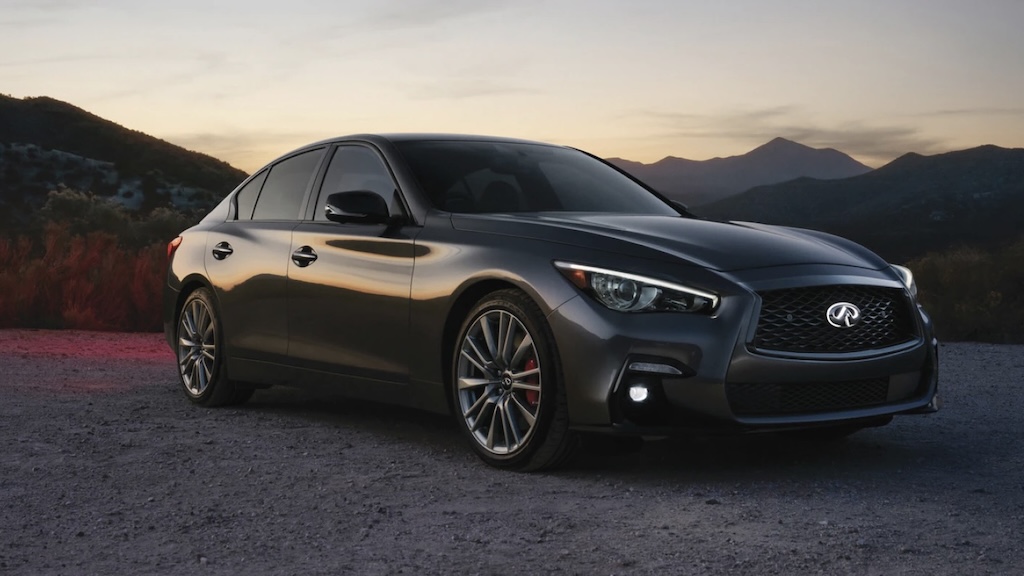 Dark gray Infiniti Q50 sedan parked at sunset