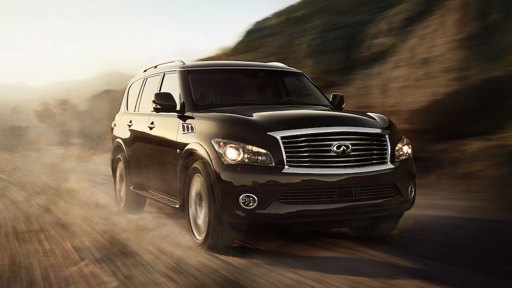 Black Infiniti QX56 SUV driving on a dirt road