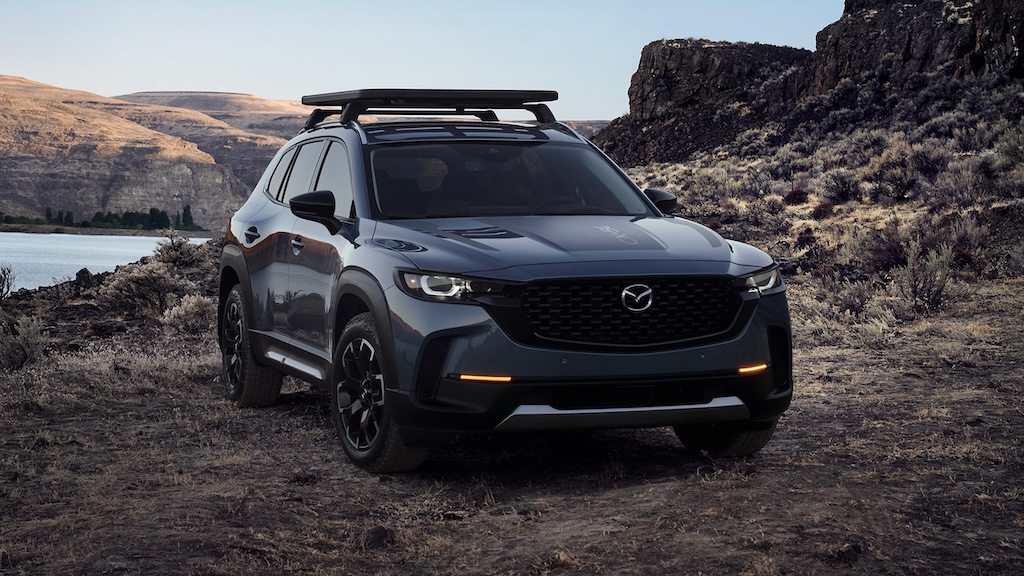 Gray Mazda CX-50 with roof rack parked in a rocky canyon