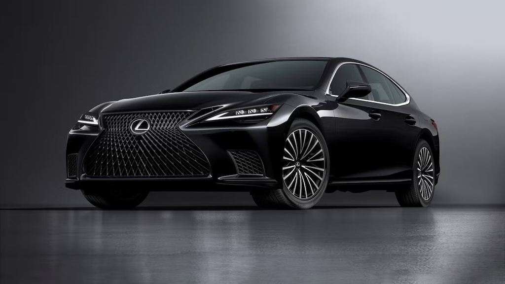 Black Lexus LS luxury sedan in a dark studio