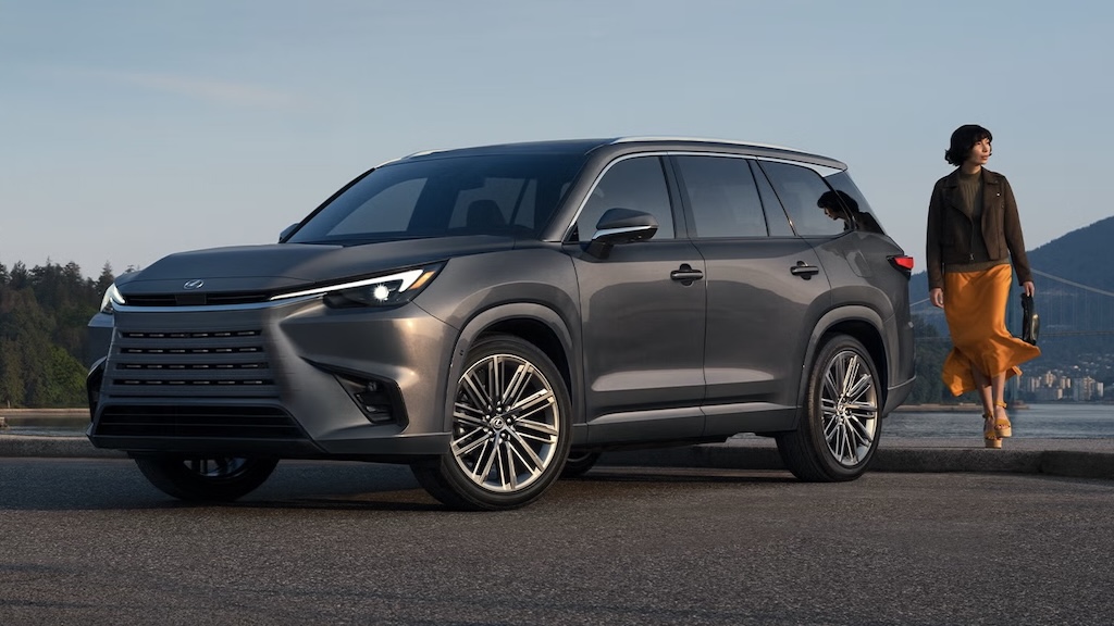 Gray Lexus TX three-row SUV parked by the waterfront