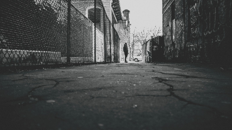 Man walking in a dark alley