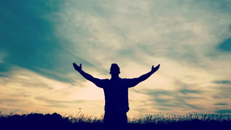 Man worshiping with arms raised
