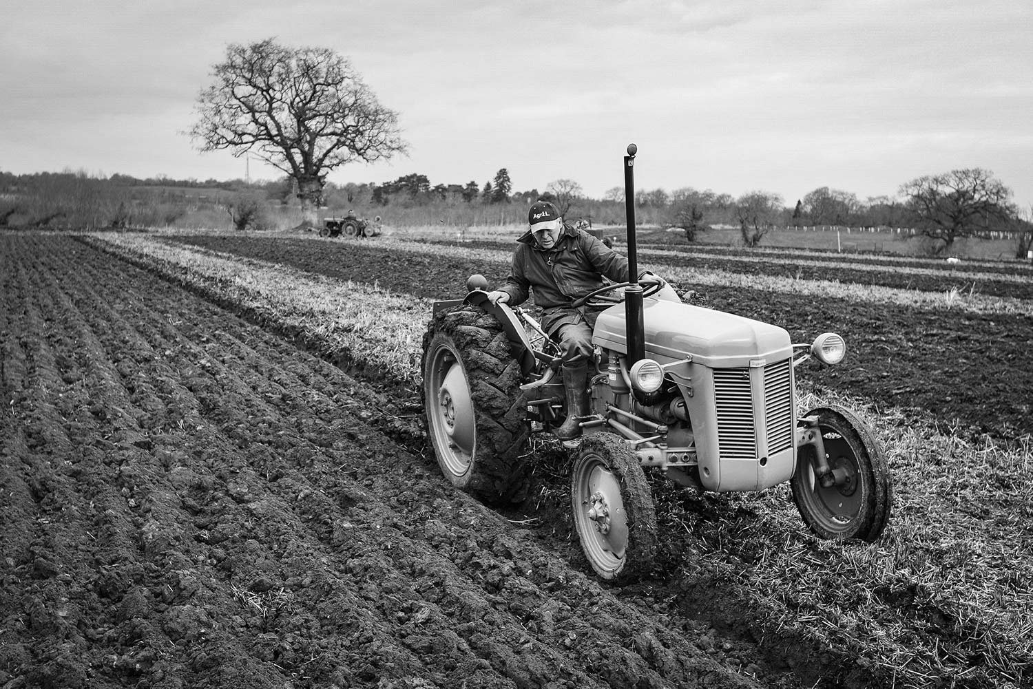 antique tractor plowing with pneumatic tractor tires