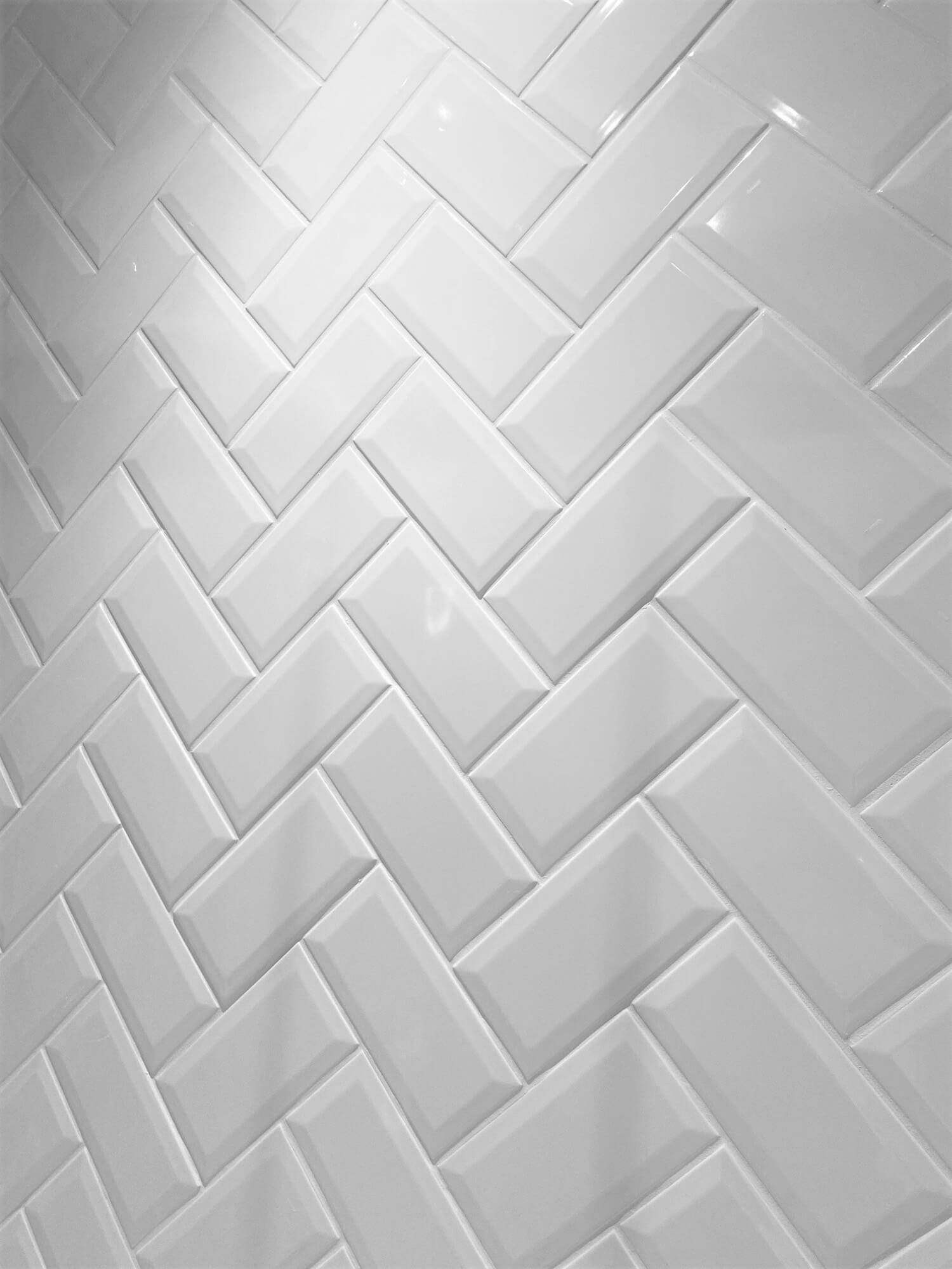 White bathroom tiles in a diagonal pattern.