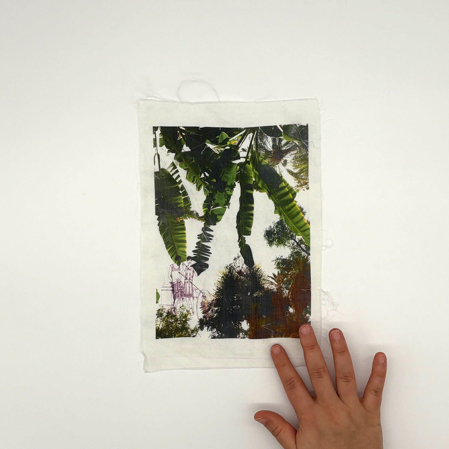 A studio photo of a designer bag and a publication printed on textile