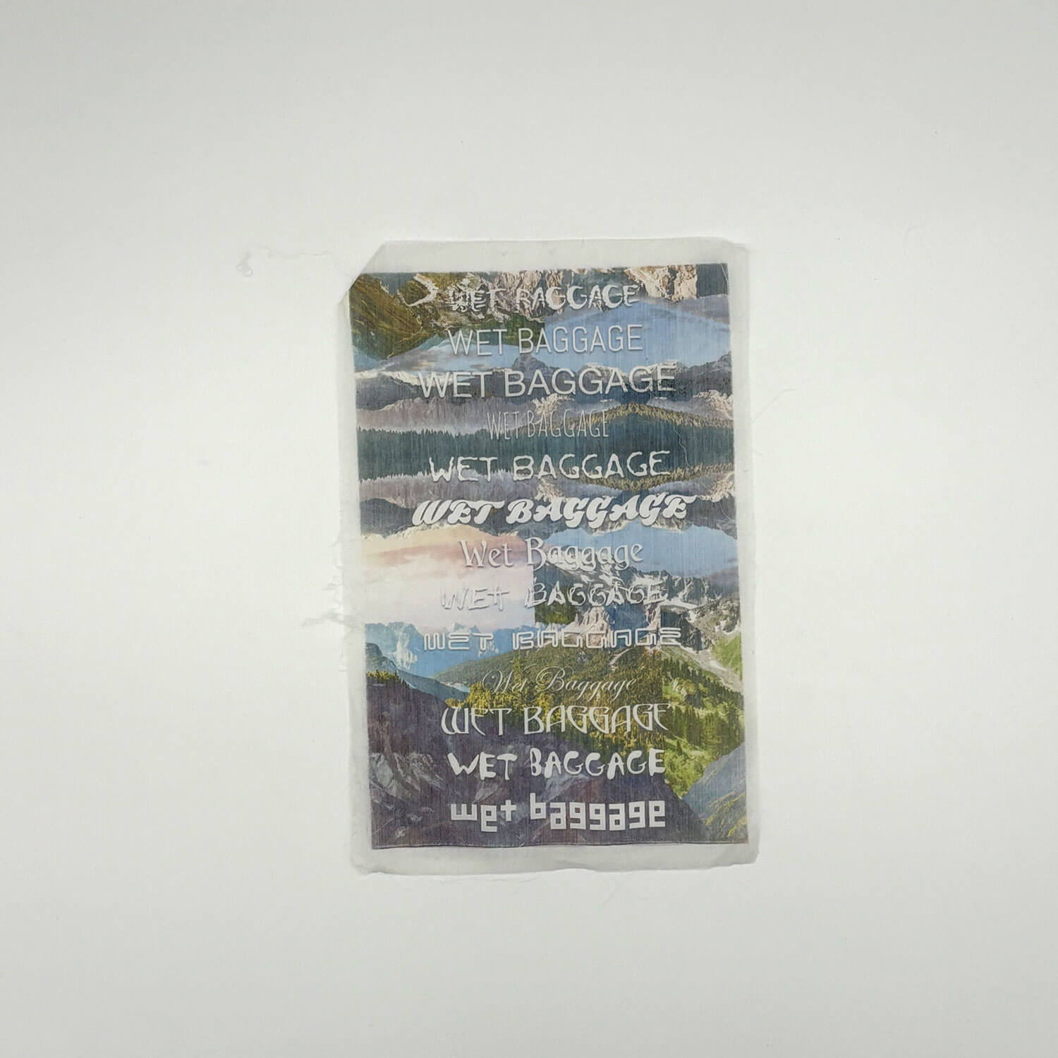 A studio photo of a designer bag and a publication printed on textile