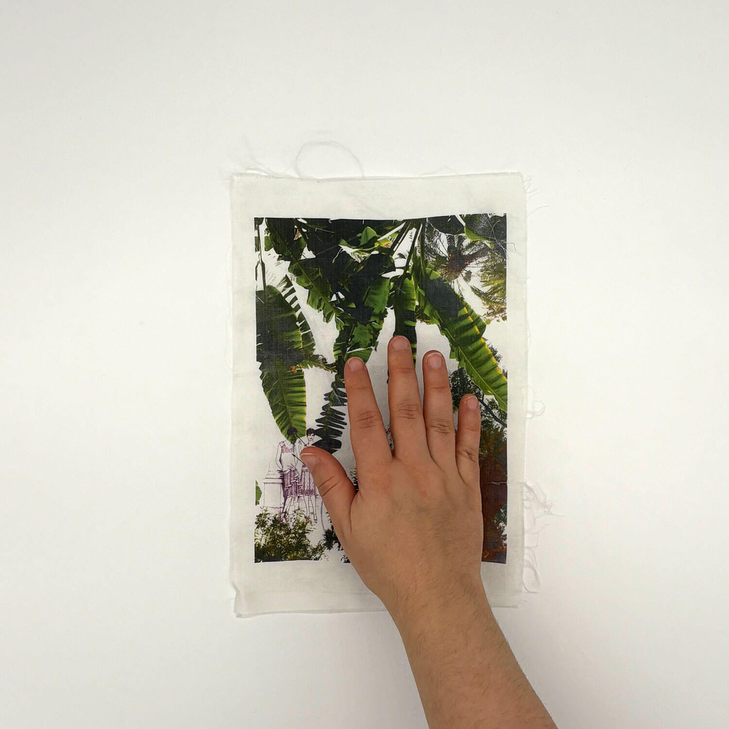 A studio photo of a designer bag and a publication printed on textile