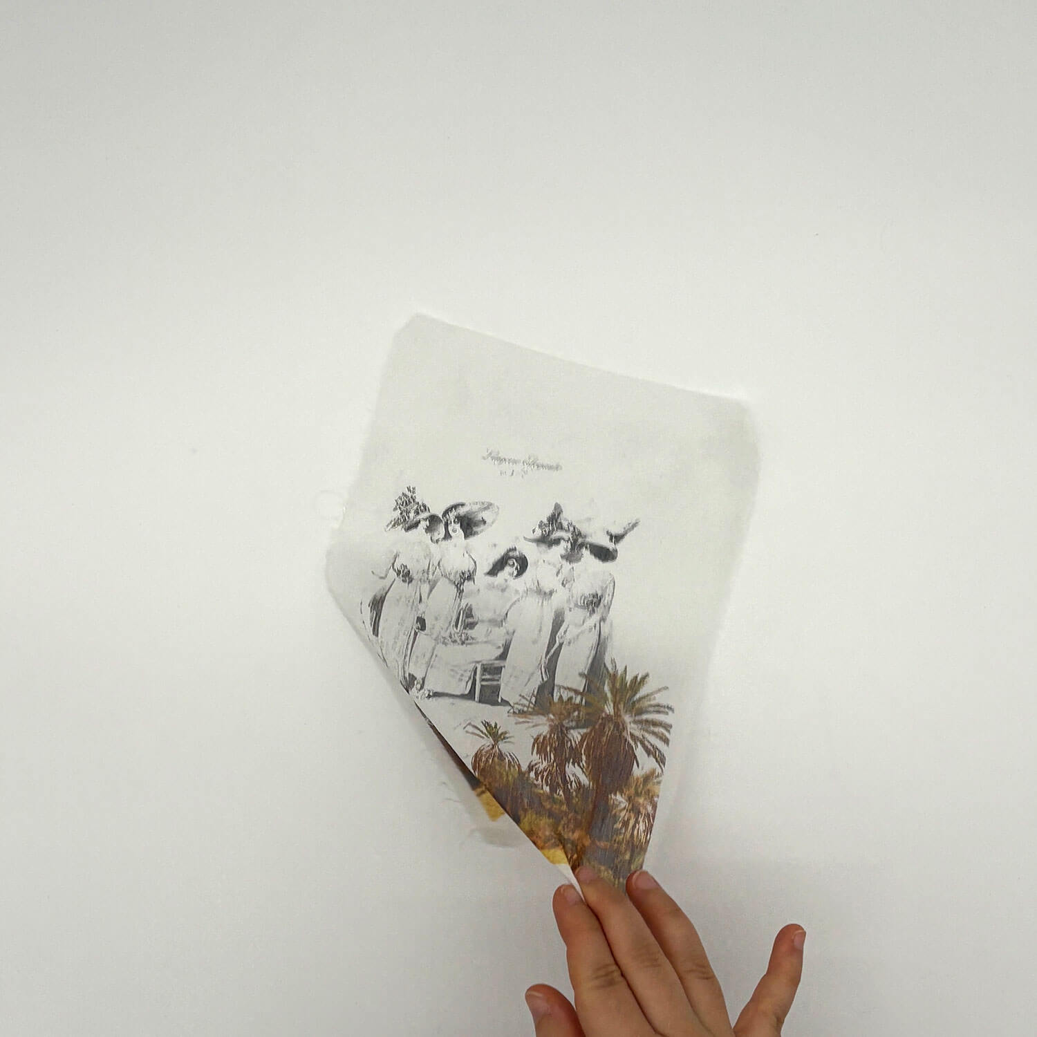 A studio photo of a designer bag and a publication printed on textile