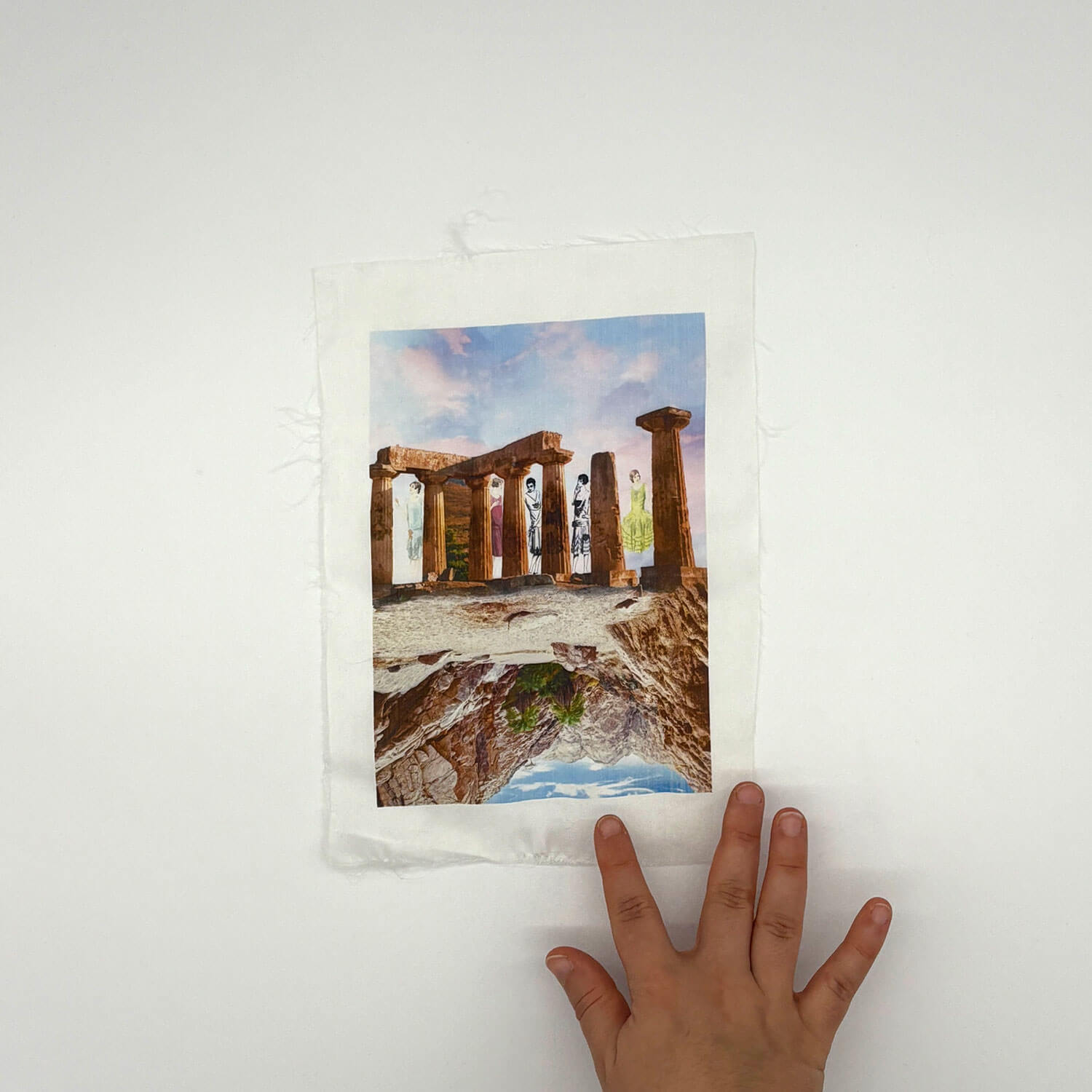 A studio photo of a designer bag and a publication printed on textile