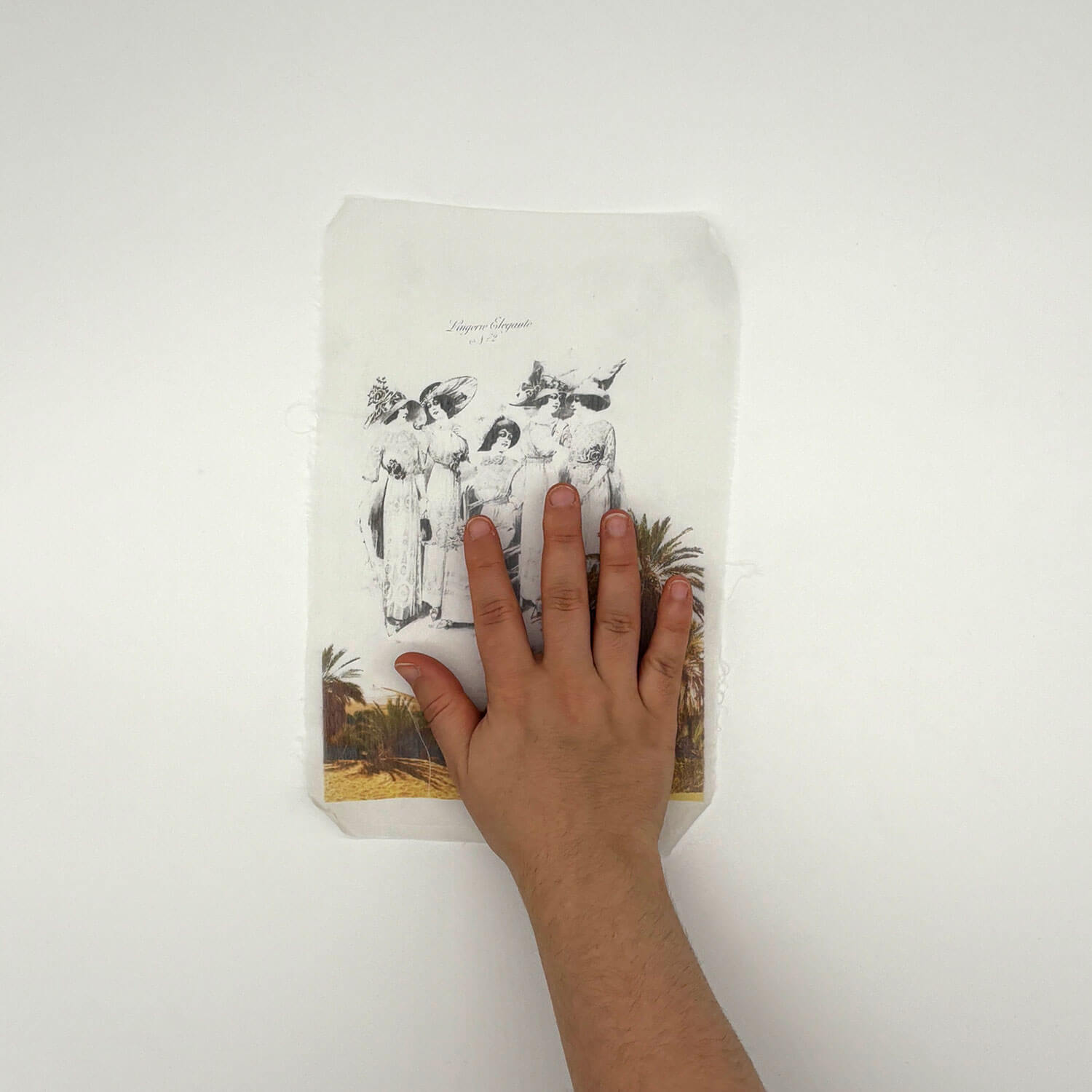 A studio photo of a designer bag and a publication printed on textile