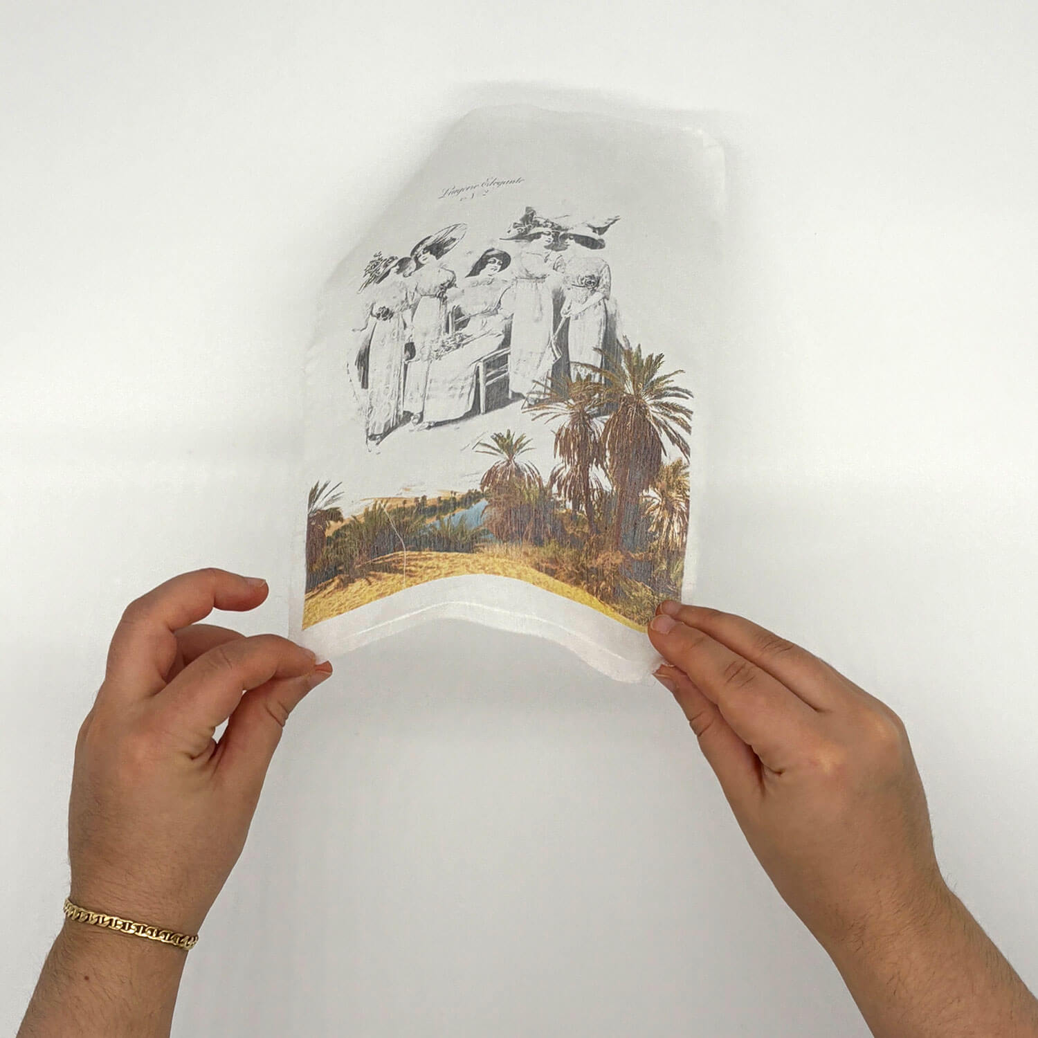 A studio photo of a designer bag and a publication printed on textile