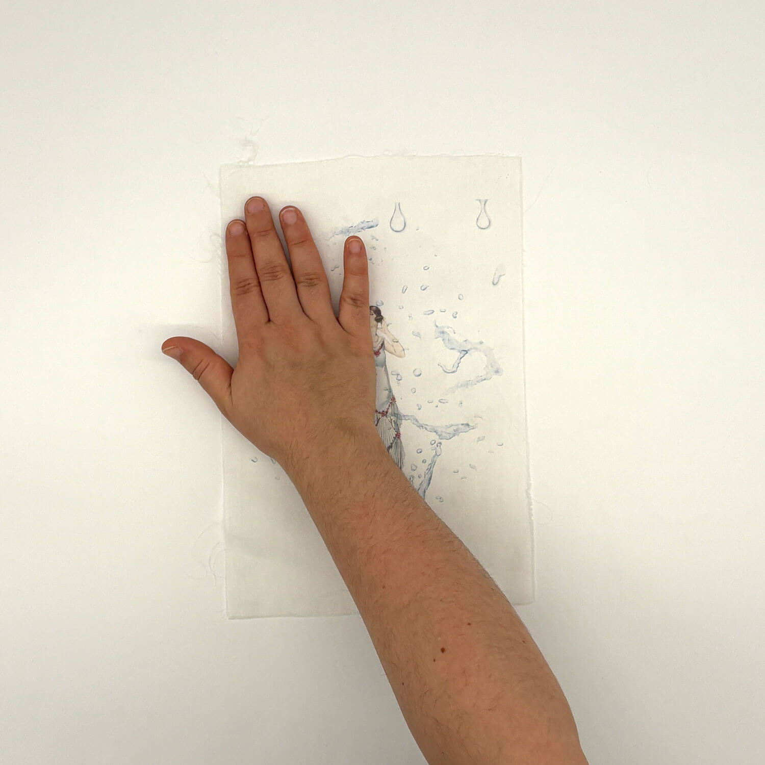 A studio photo of a designer bag and a publication printed on textile