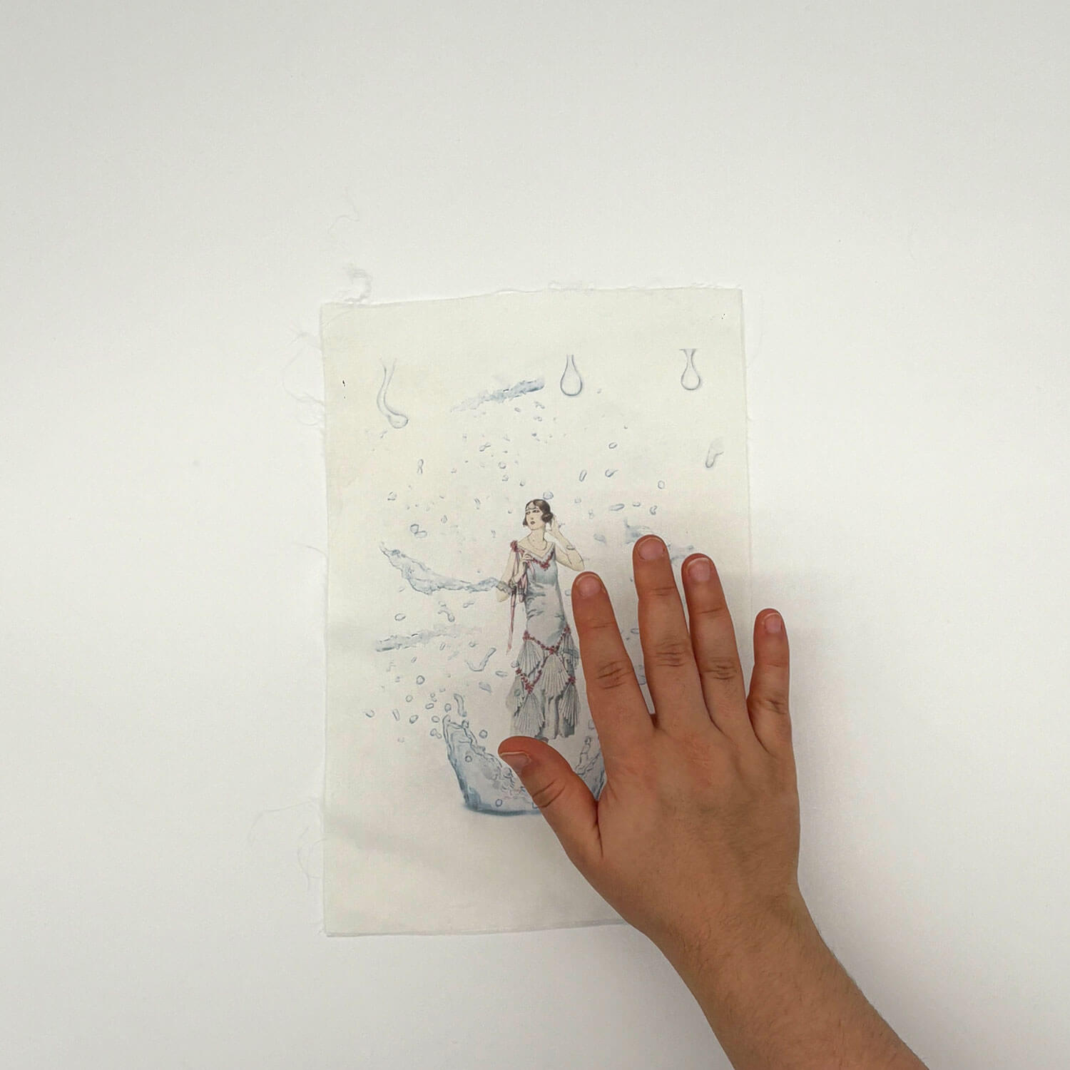 A studio photo of a designer bag and a publication printed on textile