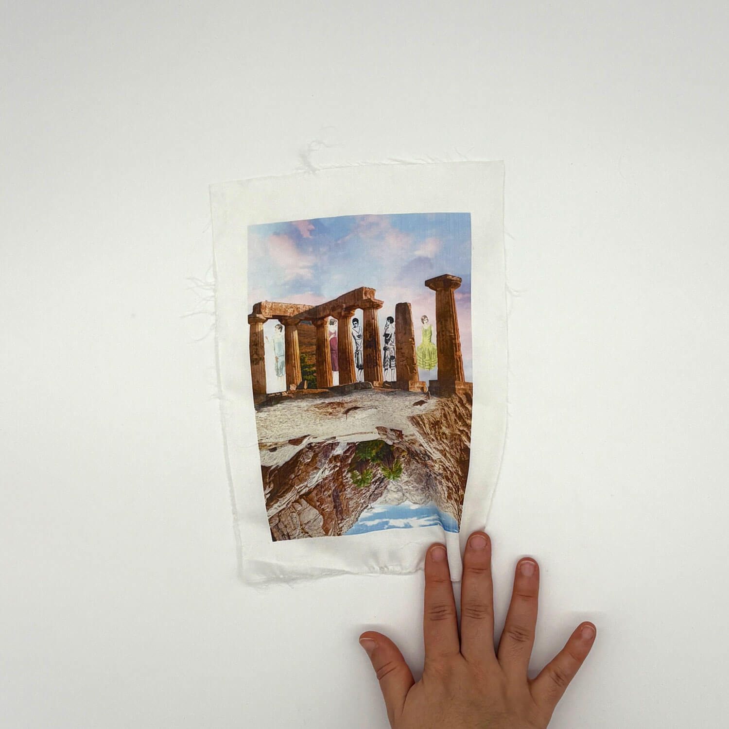 A studio photo of a designer bag and a publication printed on textile
