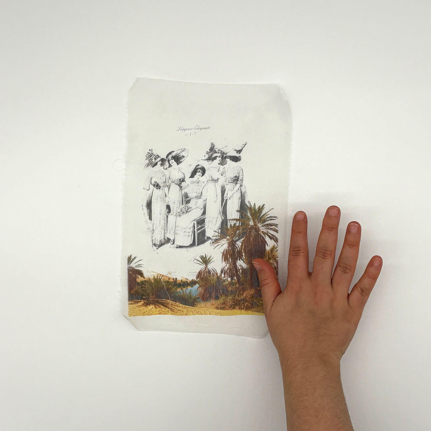 A studio photo of a designer bag and a publication printed on textile