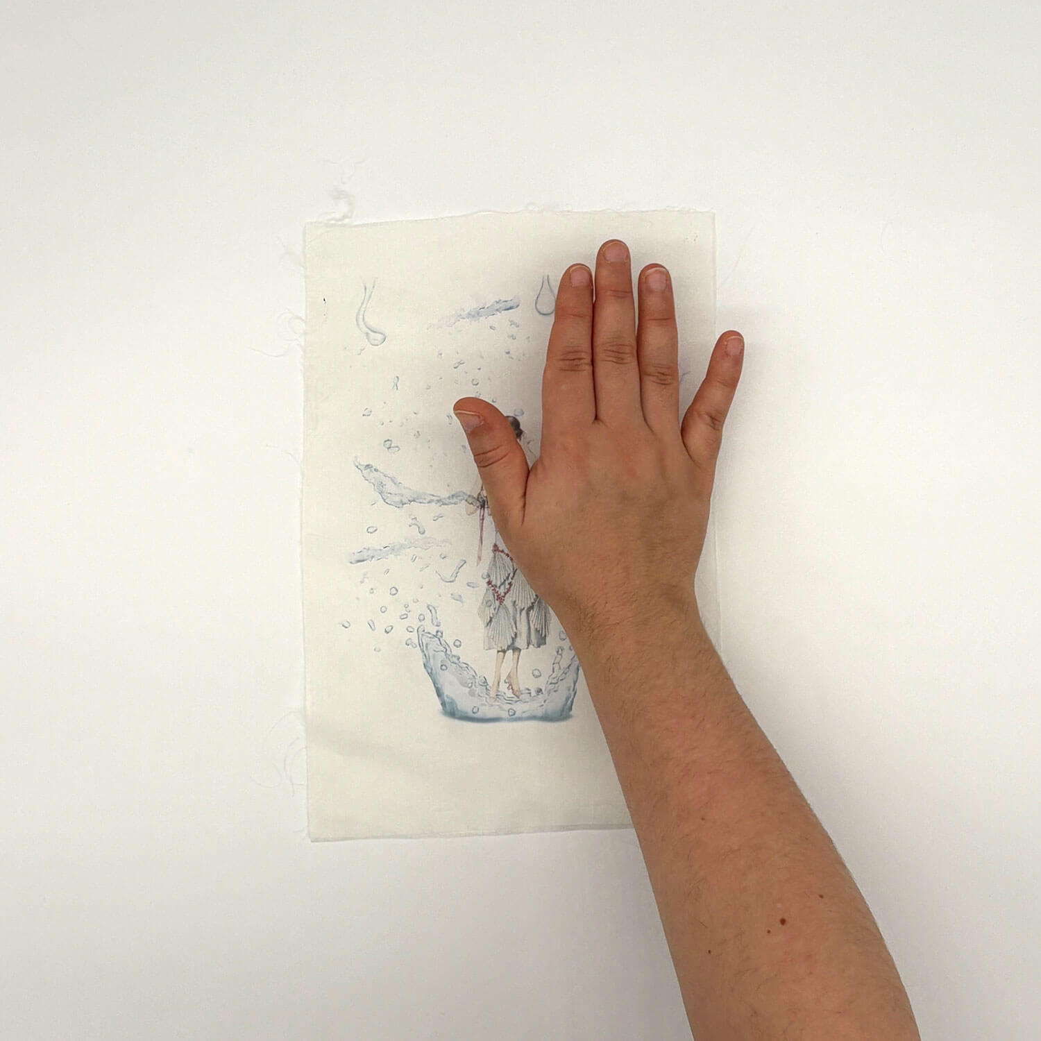 A studio photo of a designer bag and a publication printed on textile