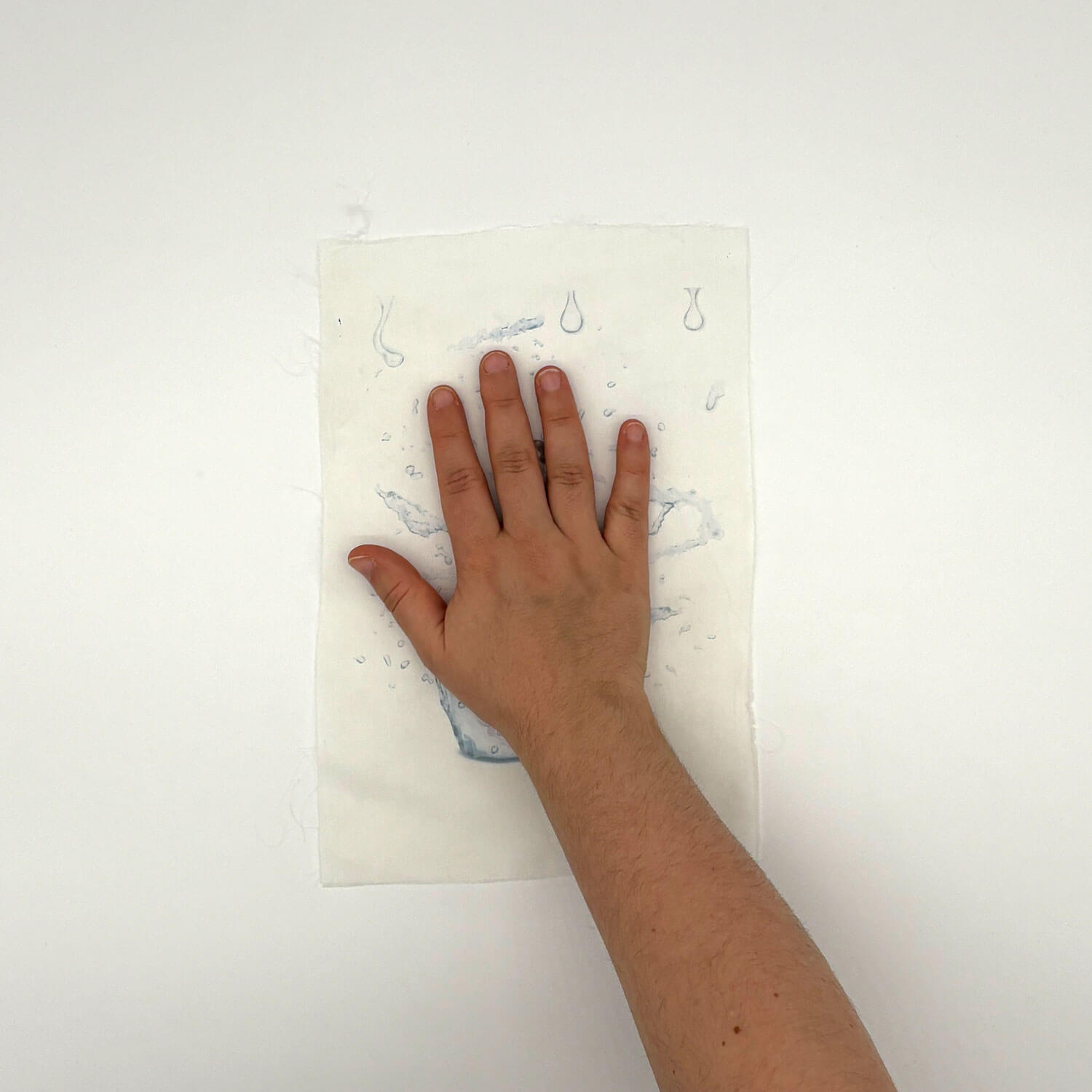 A studio photo of a designer bag and a publication printed on textile