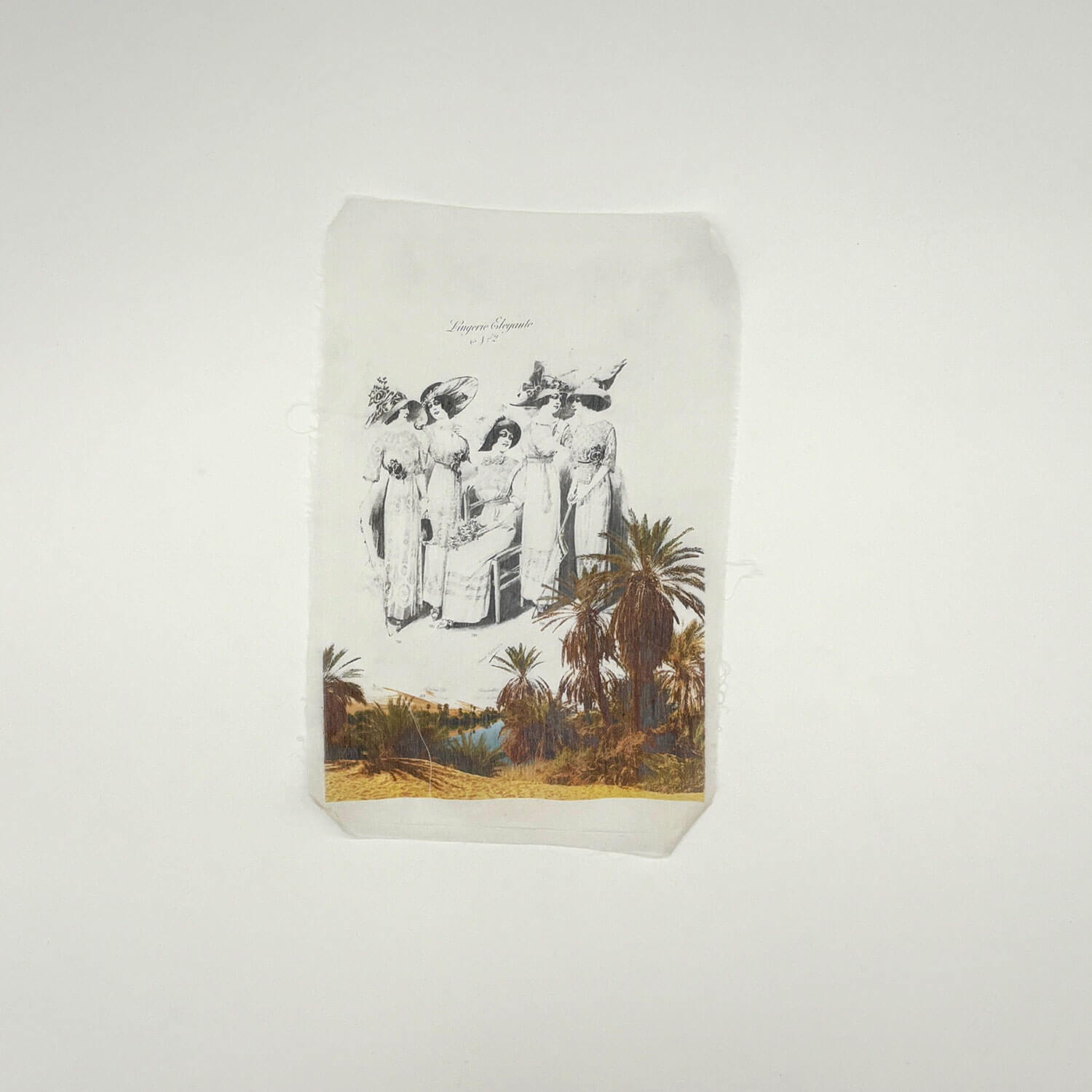 A studio photo of a designer bag and a publication printed on textile