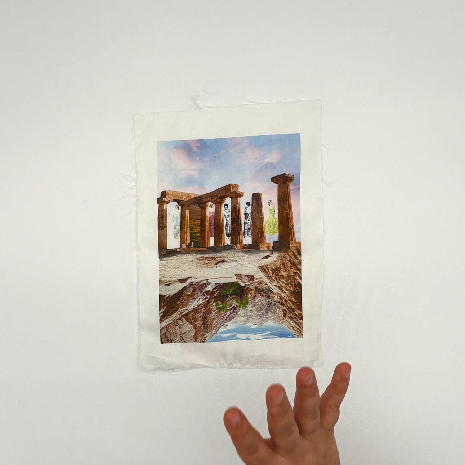A studio photo of a designer bag and a publication printed on textile
