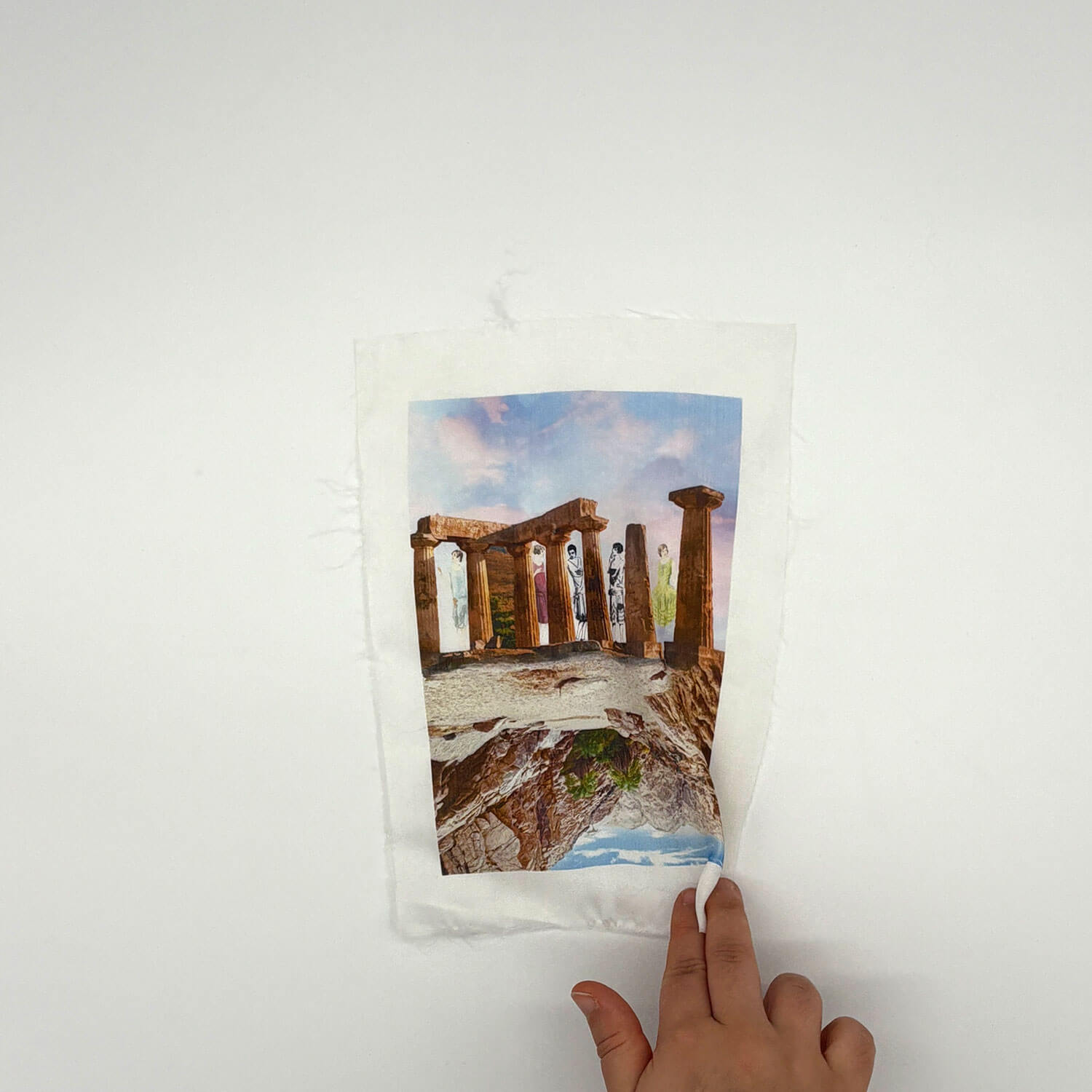 A studio photo of a designer bag and a publication printed on textile