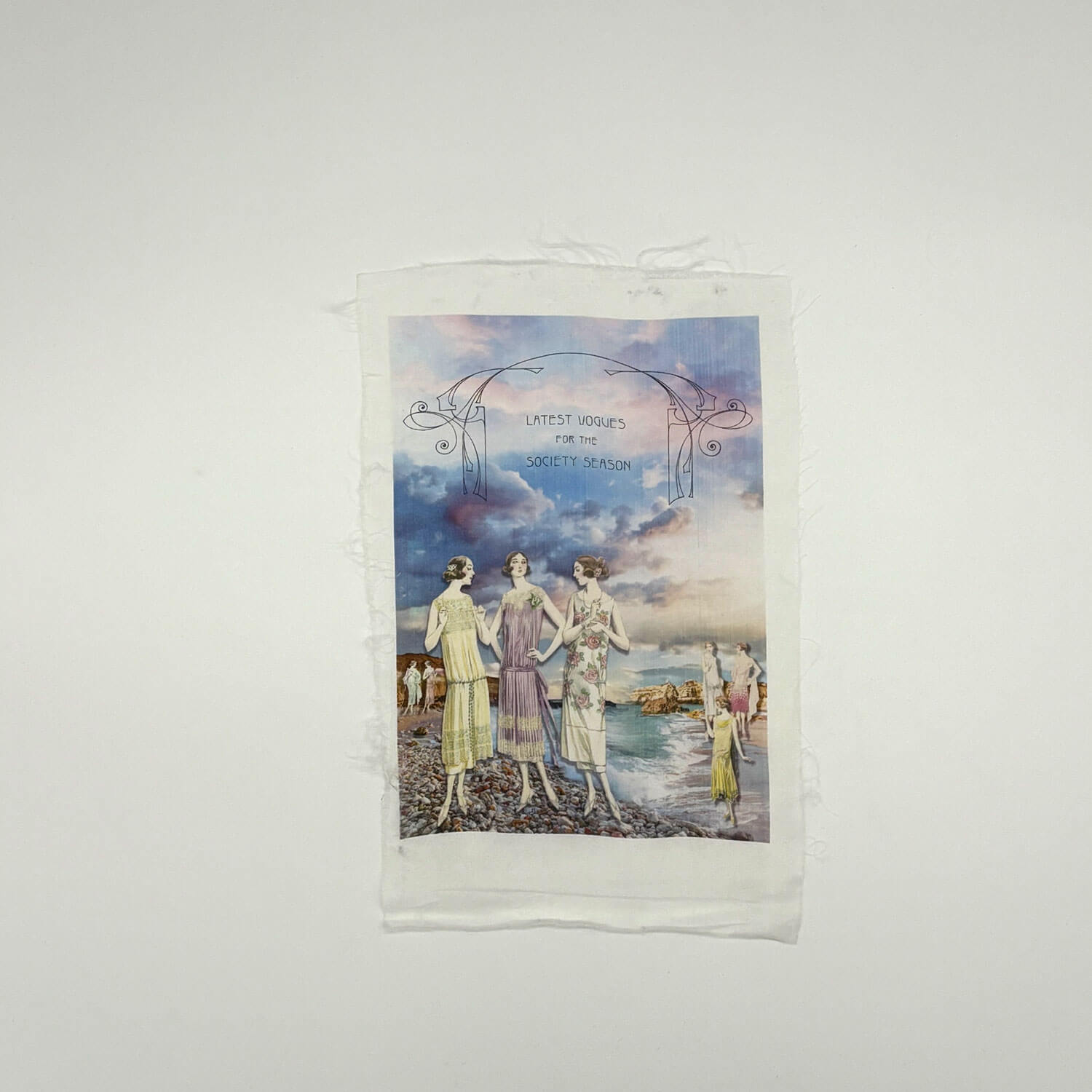 A studio photo of a designer bag and a publication printed on textile