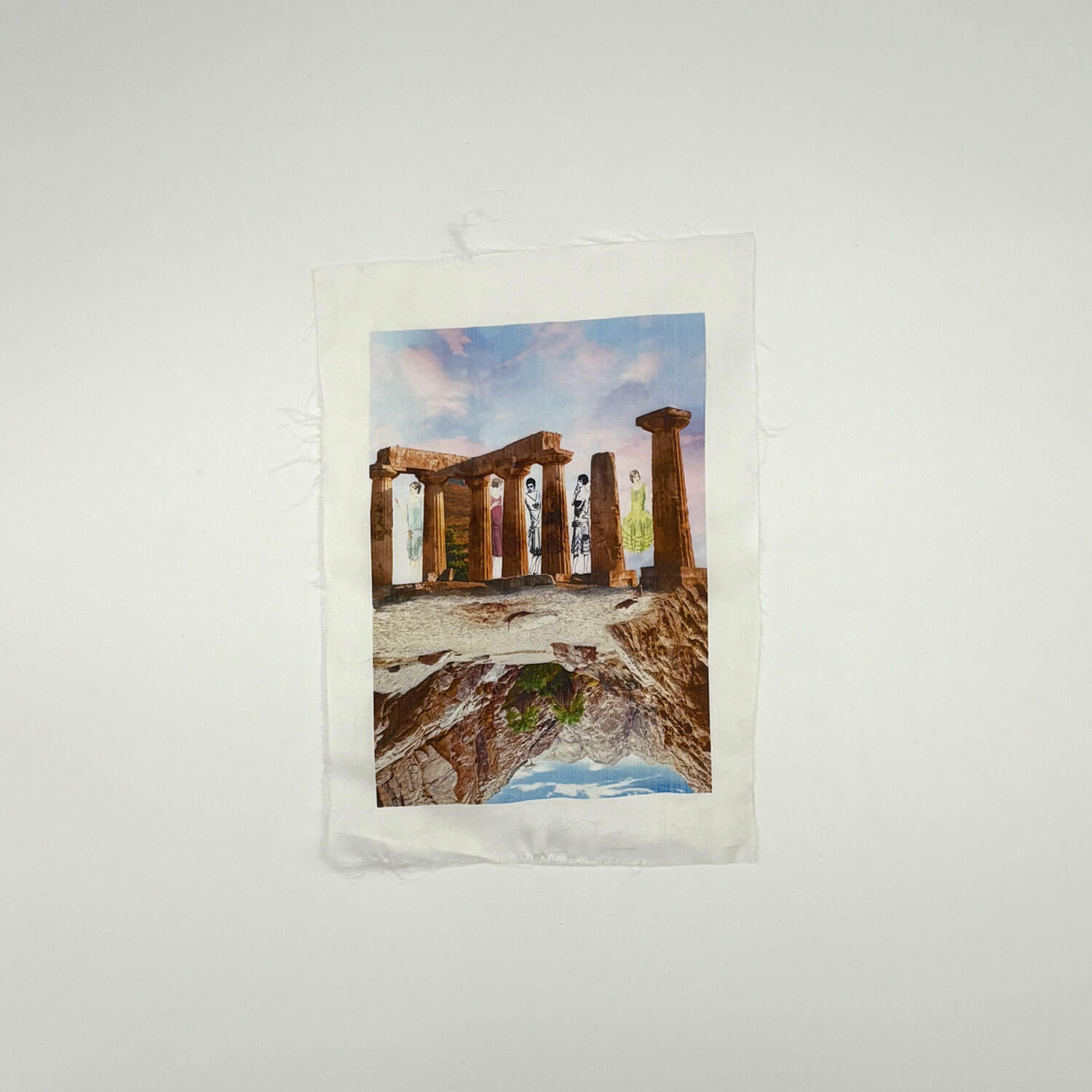 A studio photo of a designer bag and a publication printed on textile