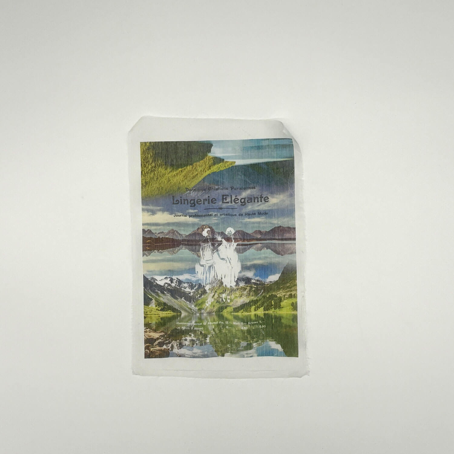 A studio photo of a designer bag and a publication printed on textile