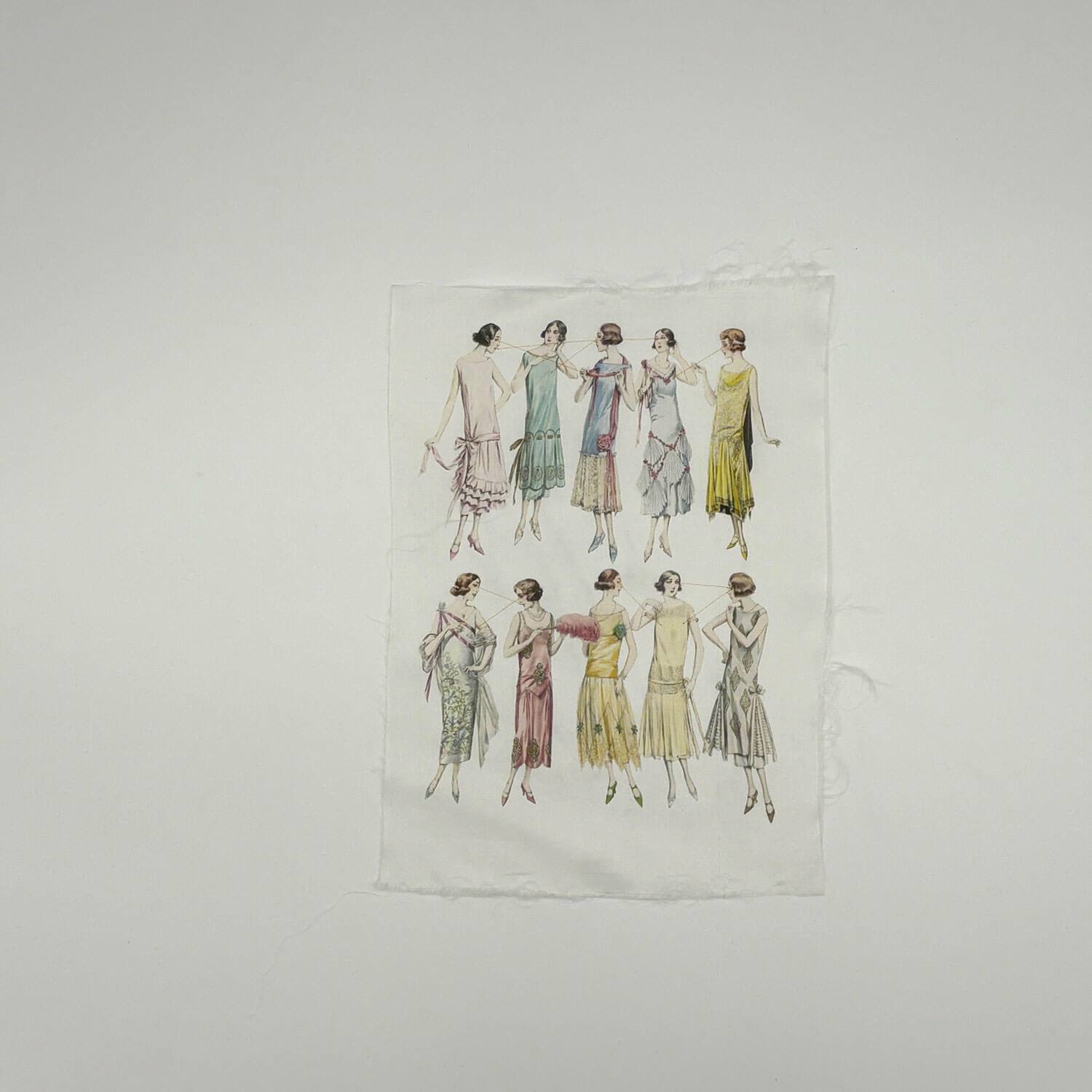 A studio photo of a designer bag and a publication printed on textile