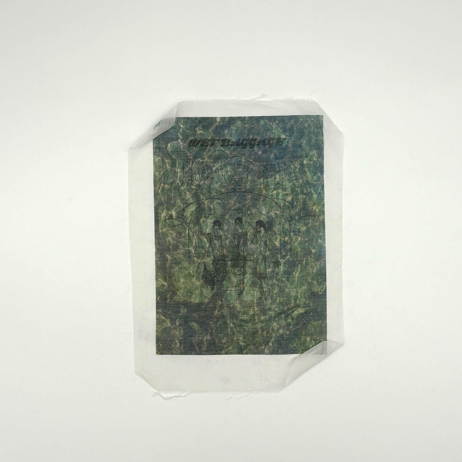 A studio photo of a designer bag and a publication printed on textile