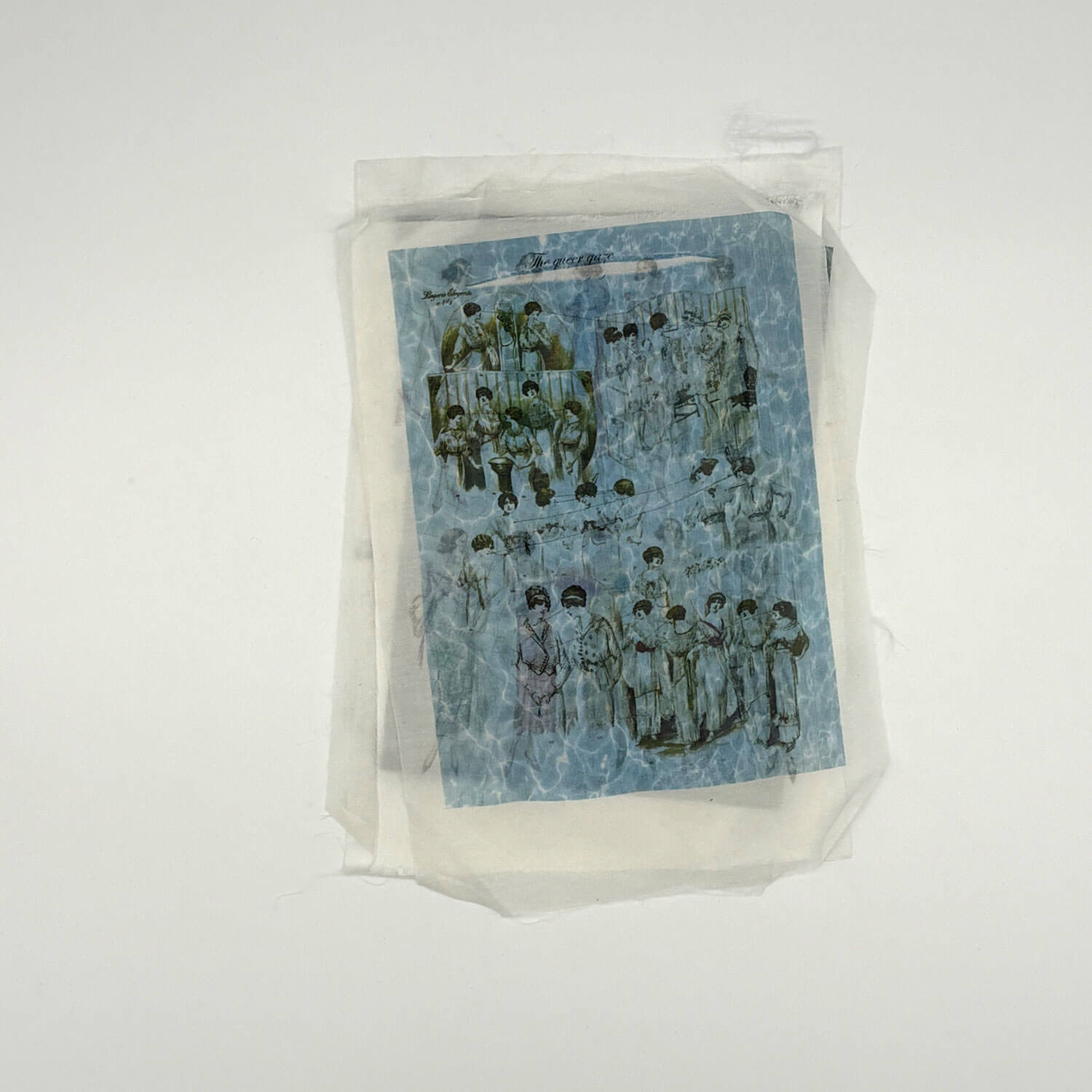 A studio photo of a designer bag and a publication printed on textile