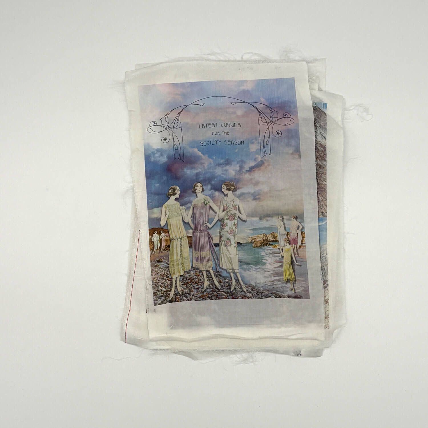 A studio photo of a designer bag and a publication printed on textile