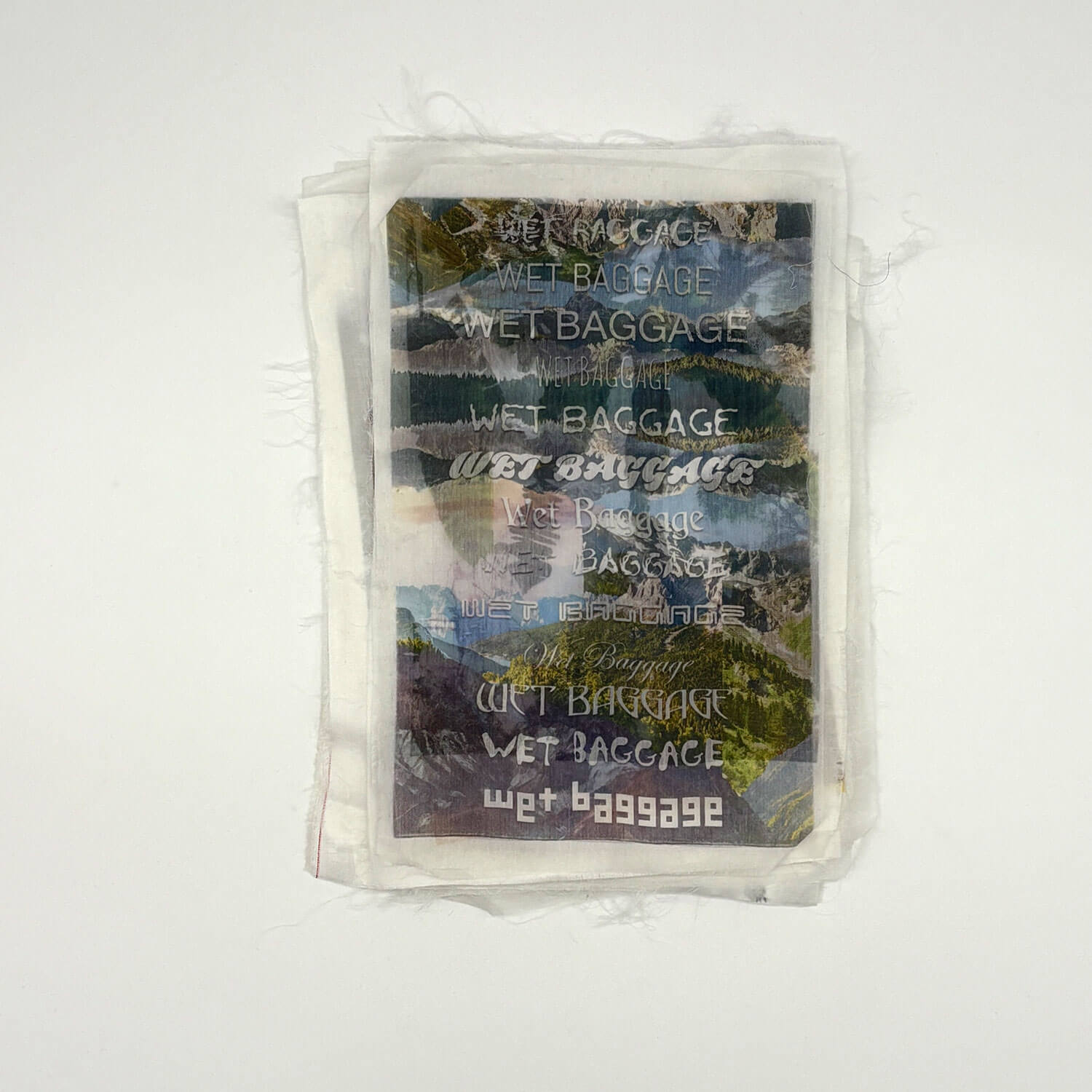 A studio photo of a designer bag and a publication printed on textile