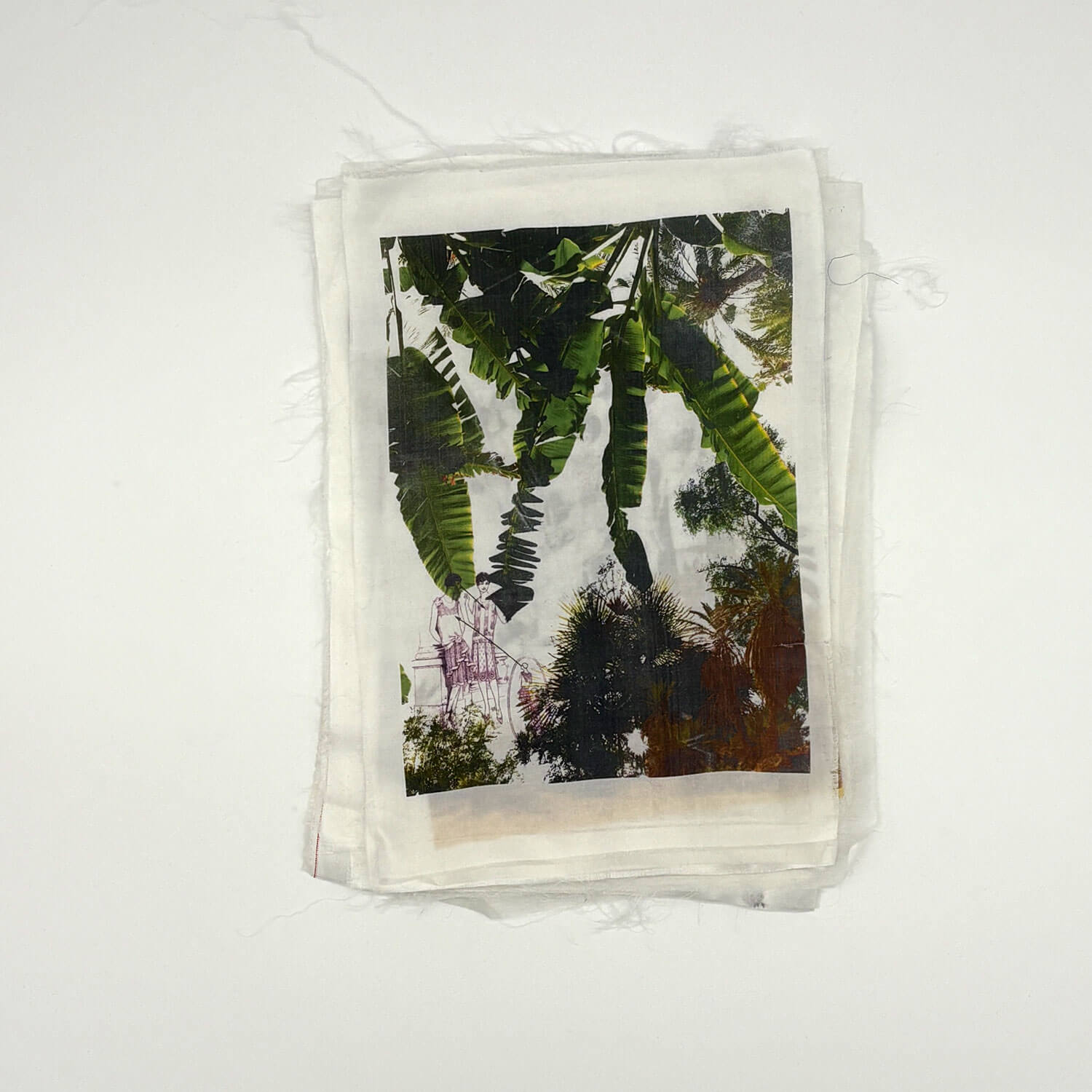 A studio photo of a designer bag and a publication printed on textile