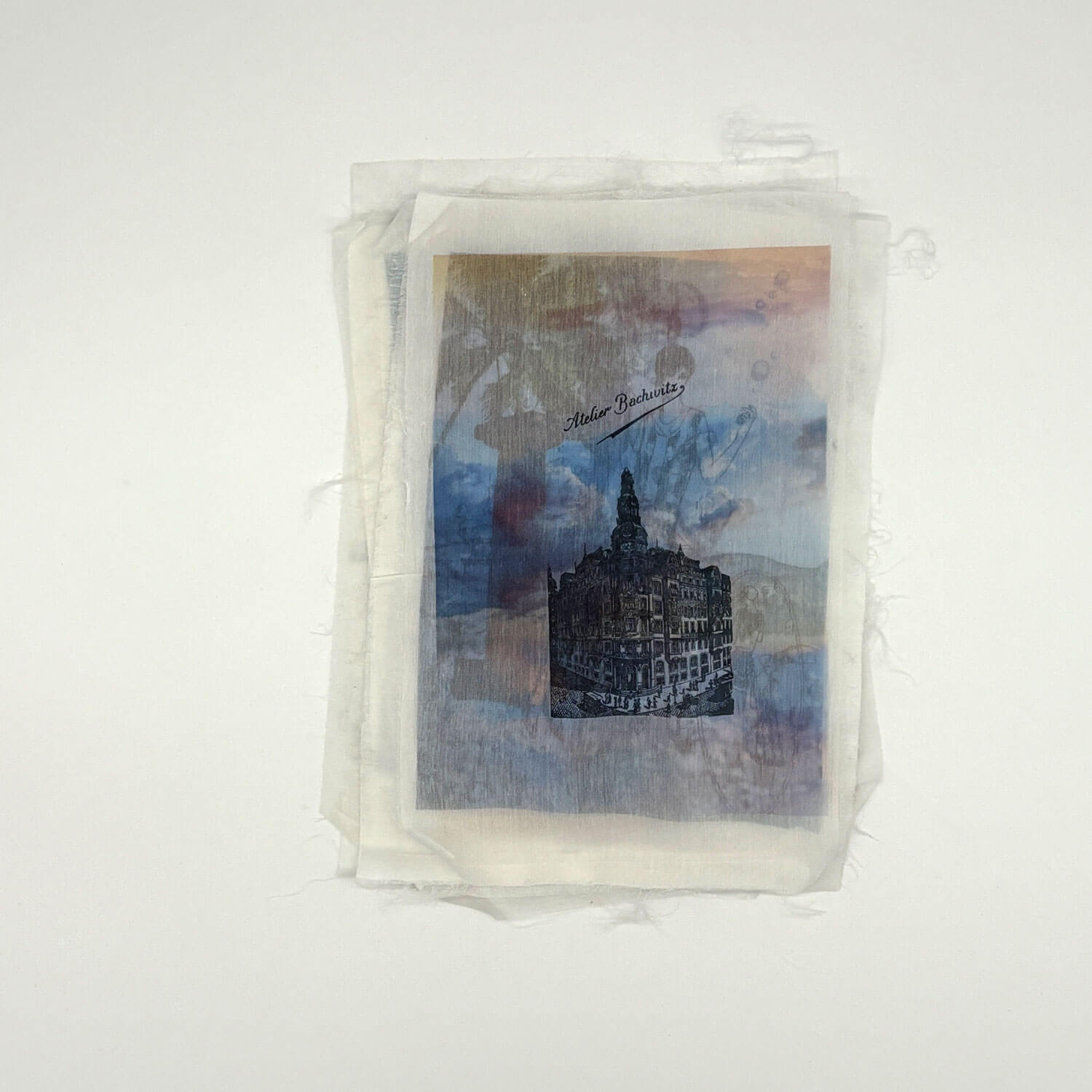 A studio photo of a designer bag and a publication printed on textile