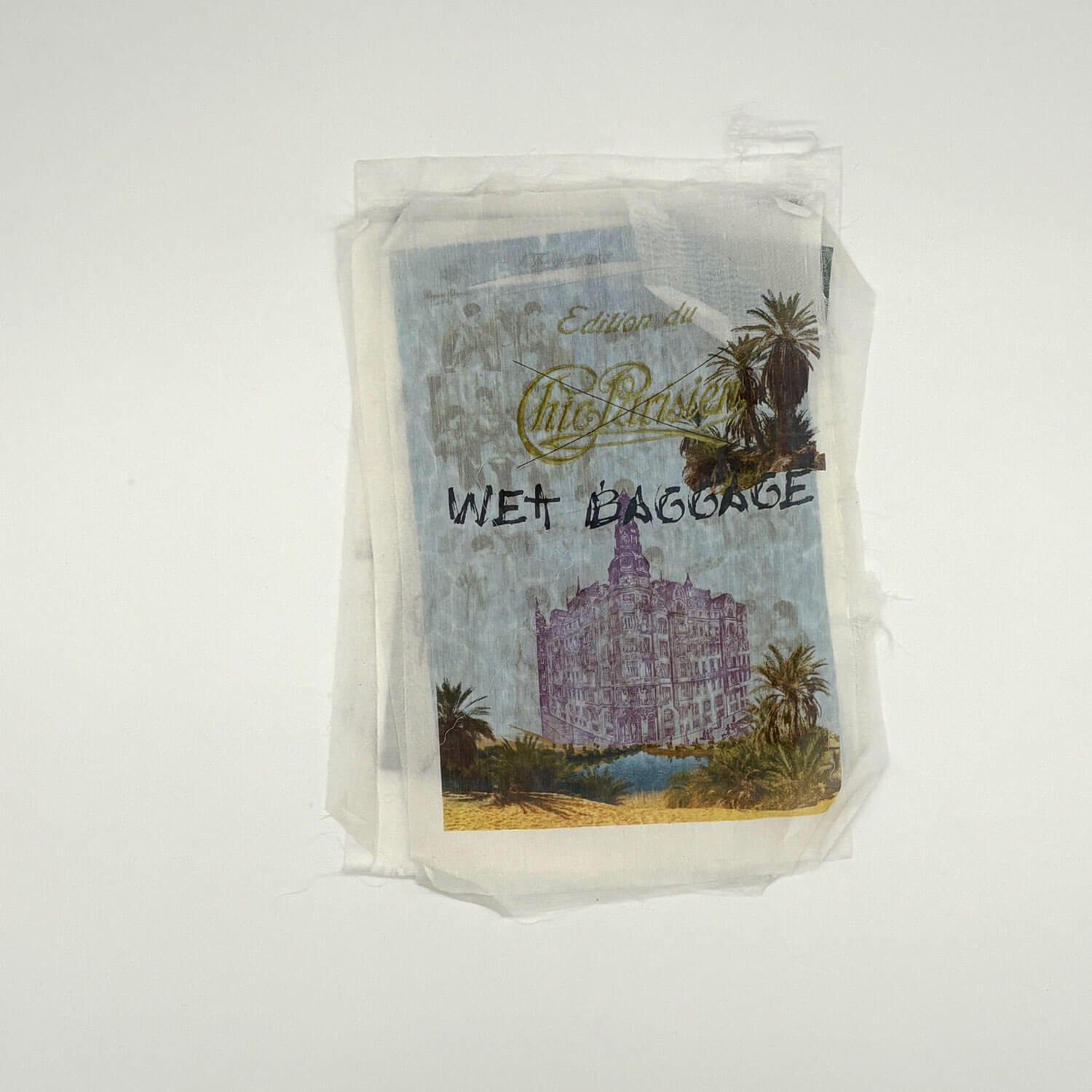 A studio photo of a designer bag and a publication printed on textile