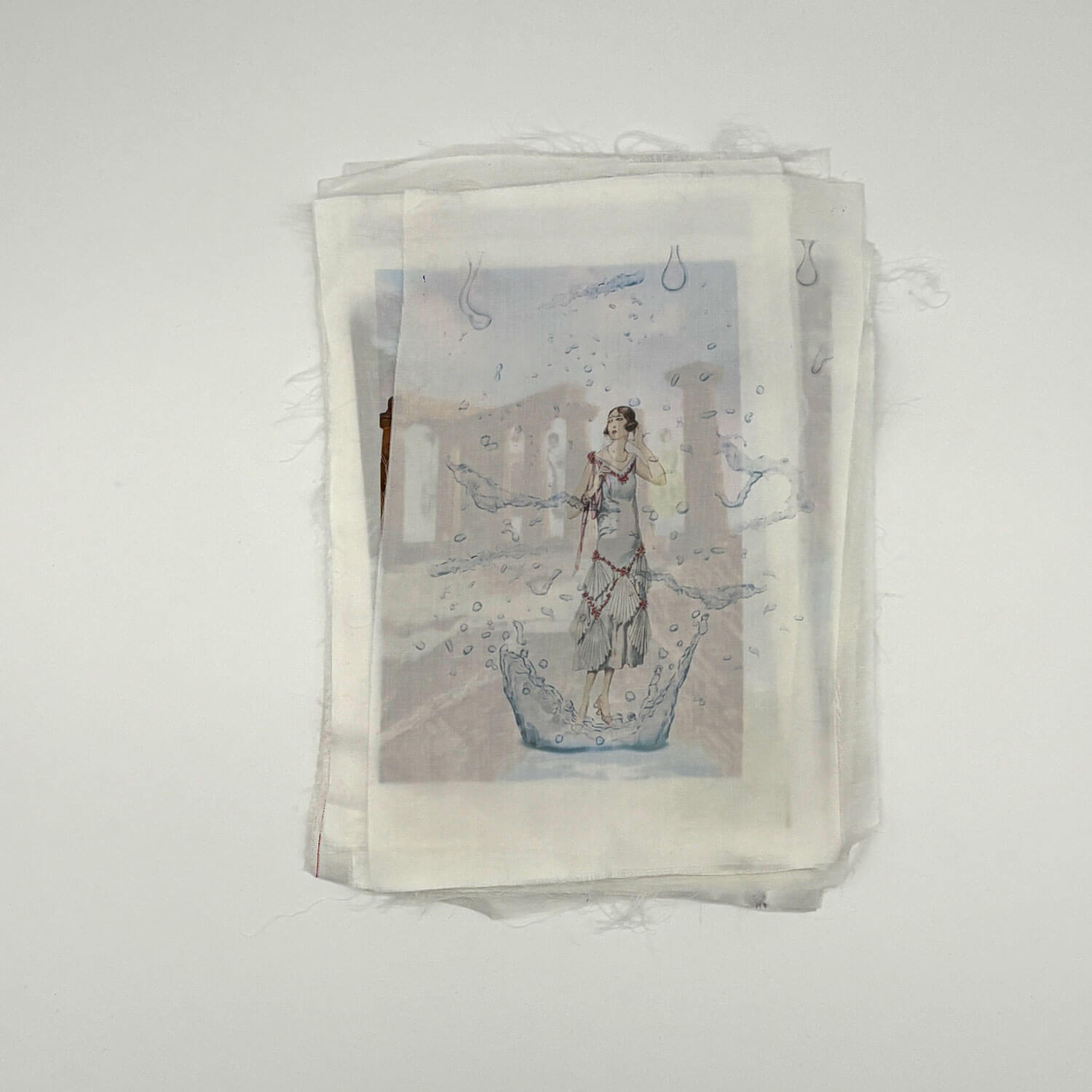 A studio photo of a designer bag and a publication printed on textile