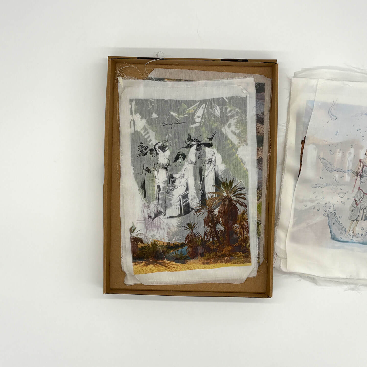 A studio photo of a designer bag and a publication printed on textile