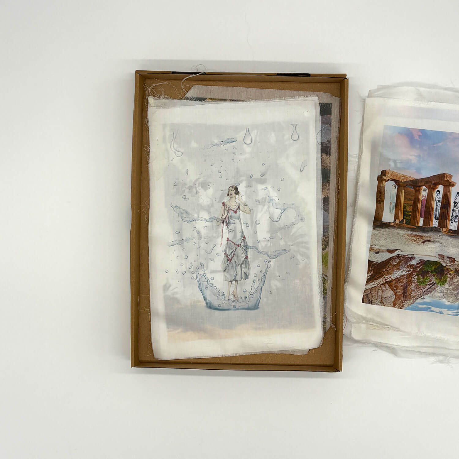 A studio photo of a designer bag and a publication printed on textile