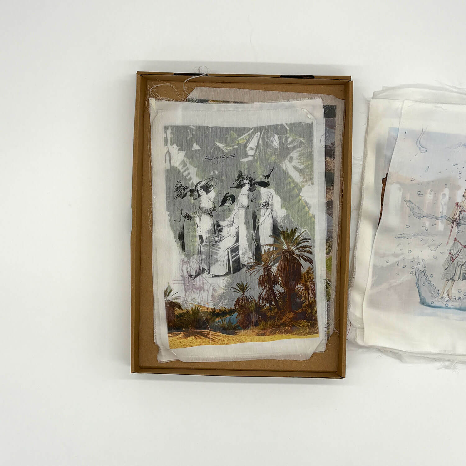 A studio photo of a designer bag and a publication printed on textile