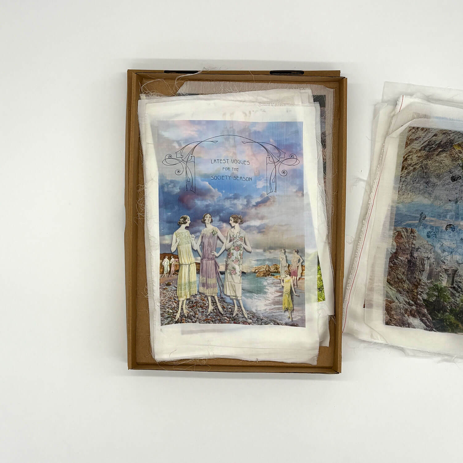 A studio photo of a designer bag and a publication printed on textile