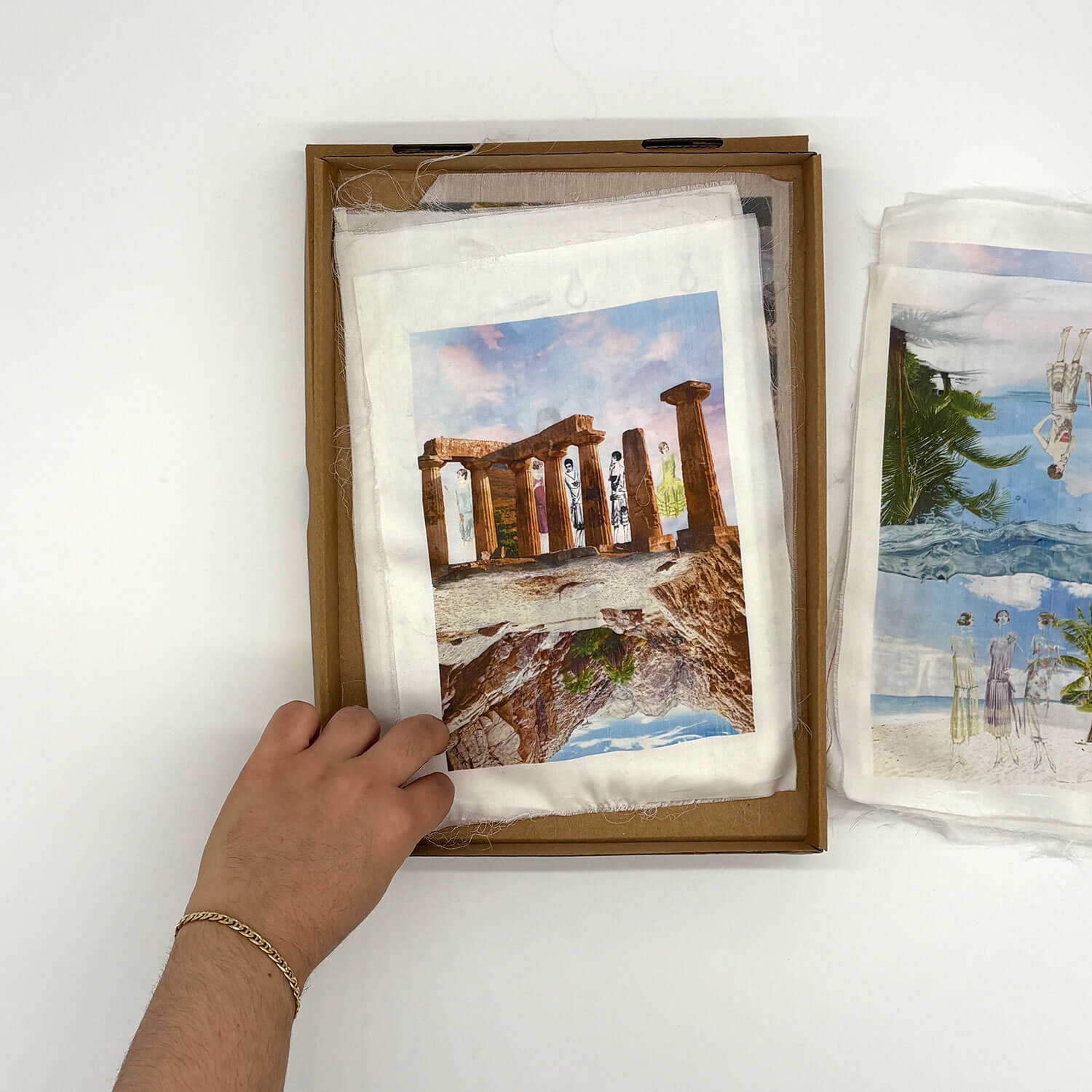A studio photo of a designer bag and a publication printed on textile