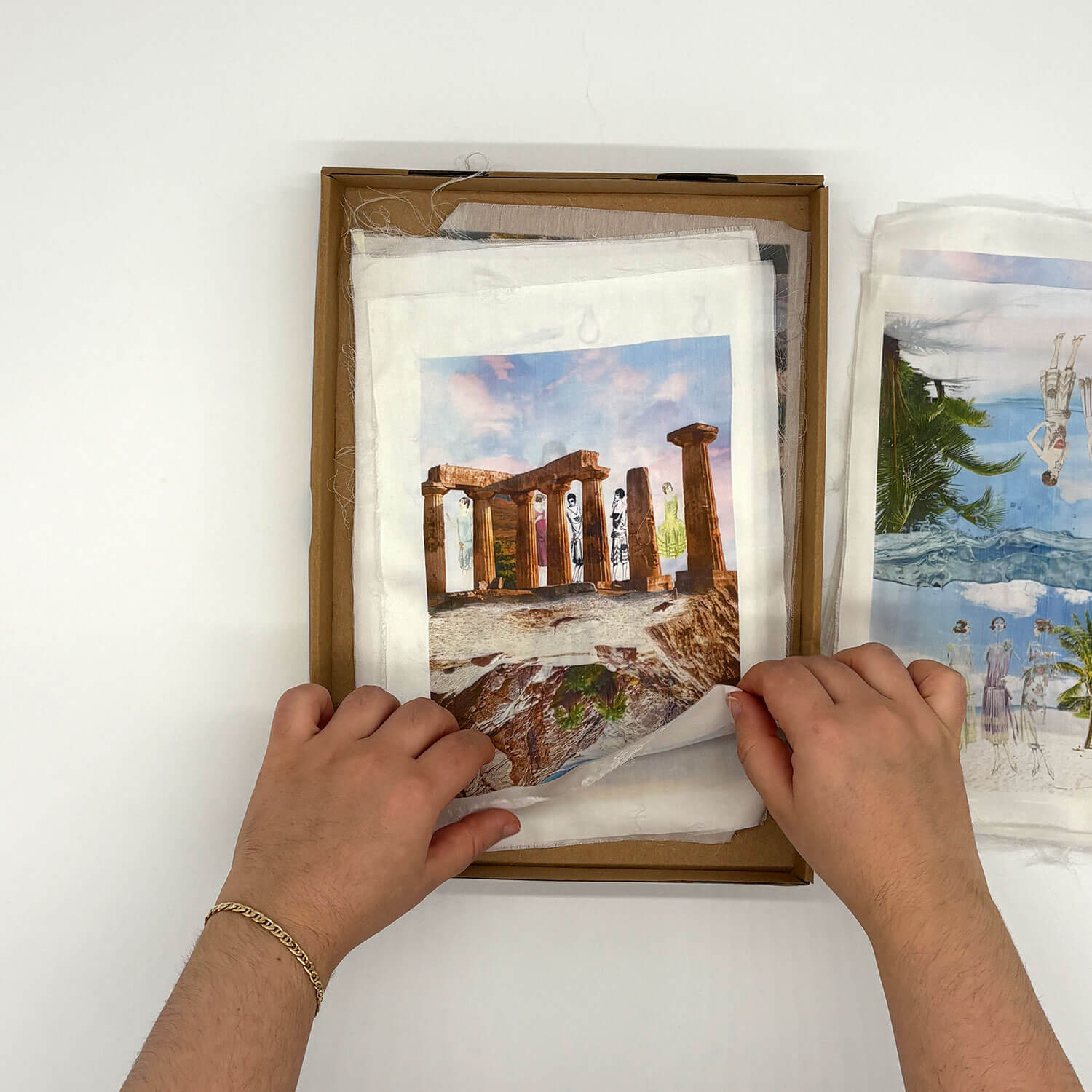 A studio photo of a designer bag and a publication printed on textile