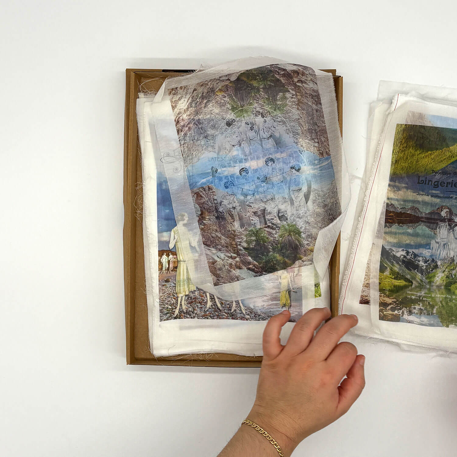 A studio photo of a designer bag and a publication printed on textile